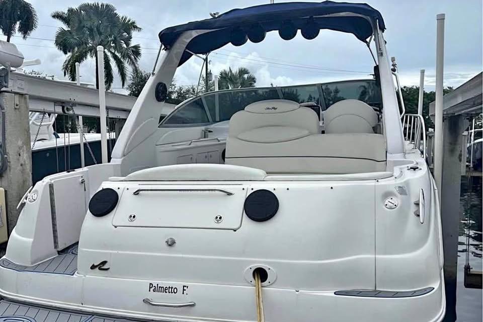 2001 Sea Ray 340 Sundancer yacht docked, featuring sleek design and comfortable seating.