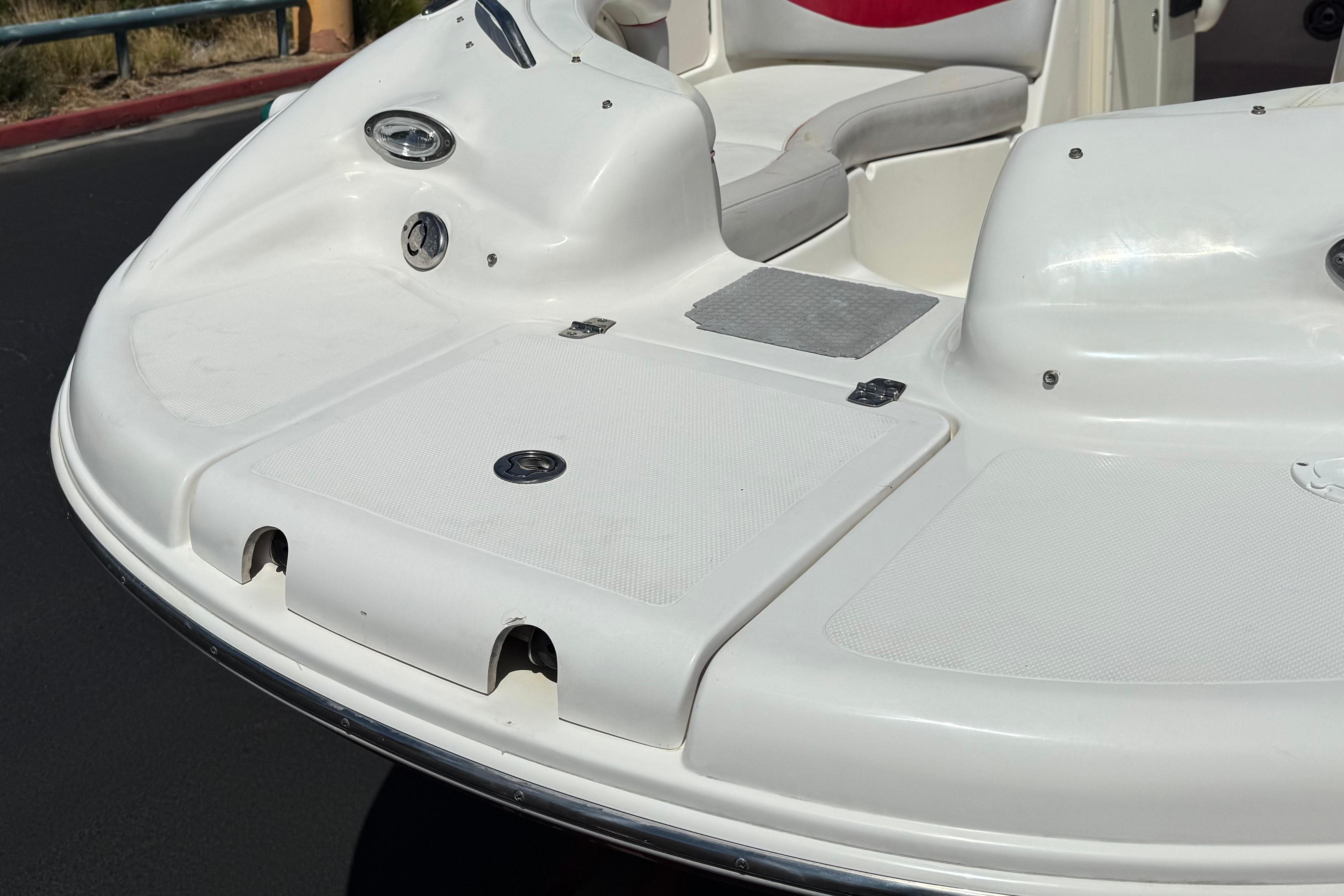 2010 Bryant 255 boat deck with seating and storage compartments.