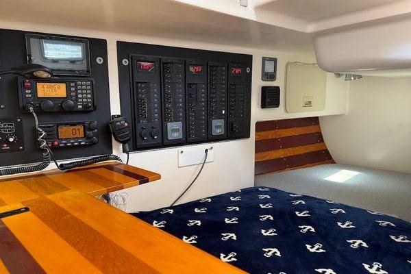 Interior of a 2011 Reliance 44 sailboat with navigation equipment and cozy sleeping area.