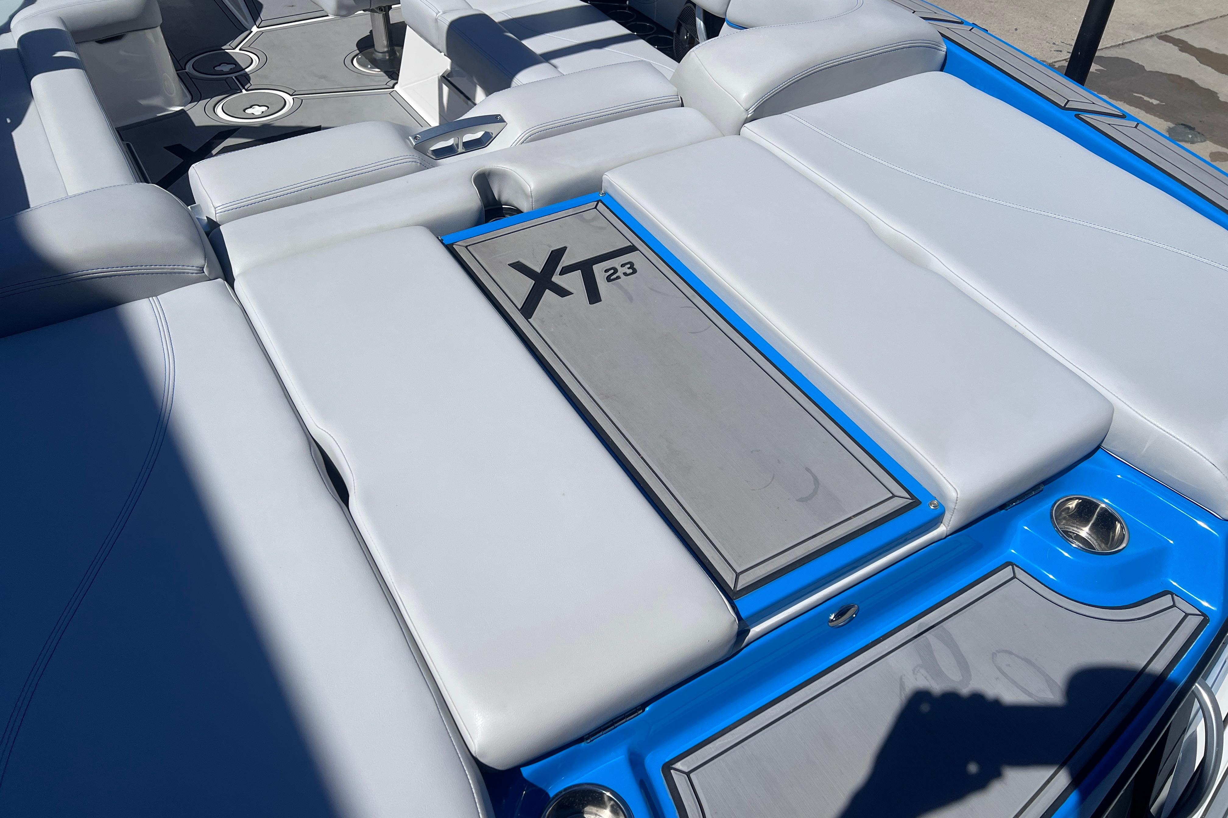 2021 MasterCraft XT23 boat interior with gray seating and blue accents.