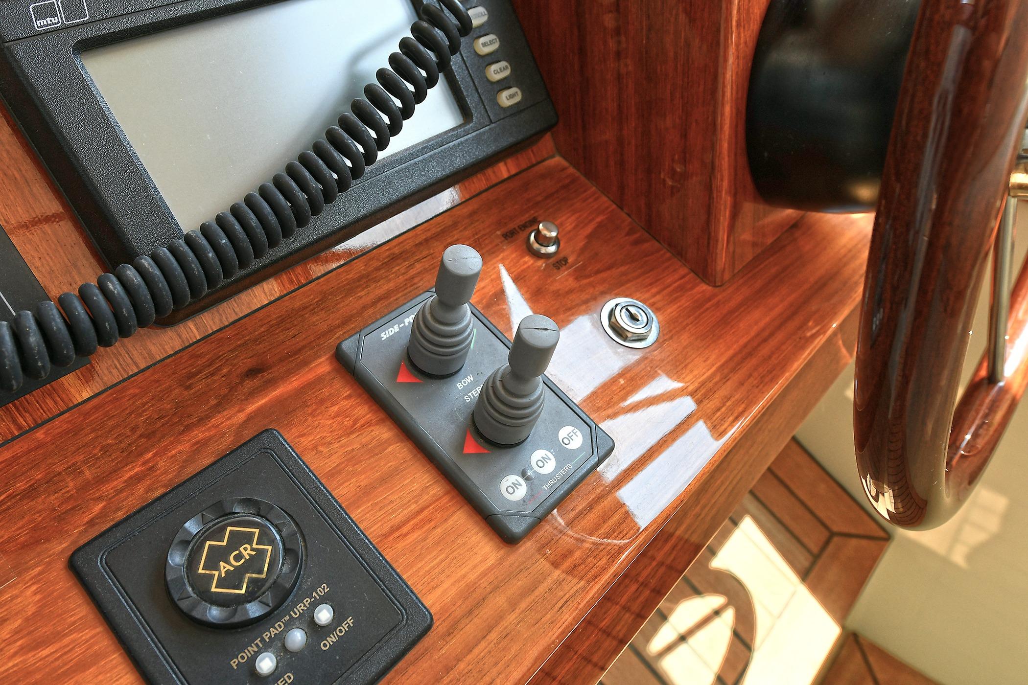 Control panel of a 2005 San Juan Downeast Express boat with joystick and ACR system.