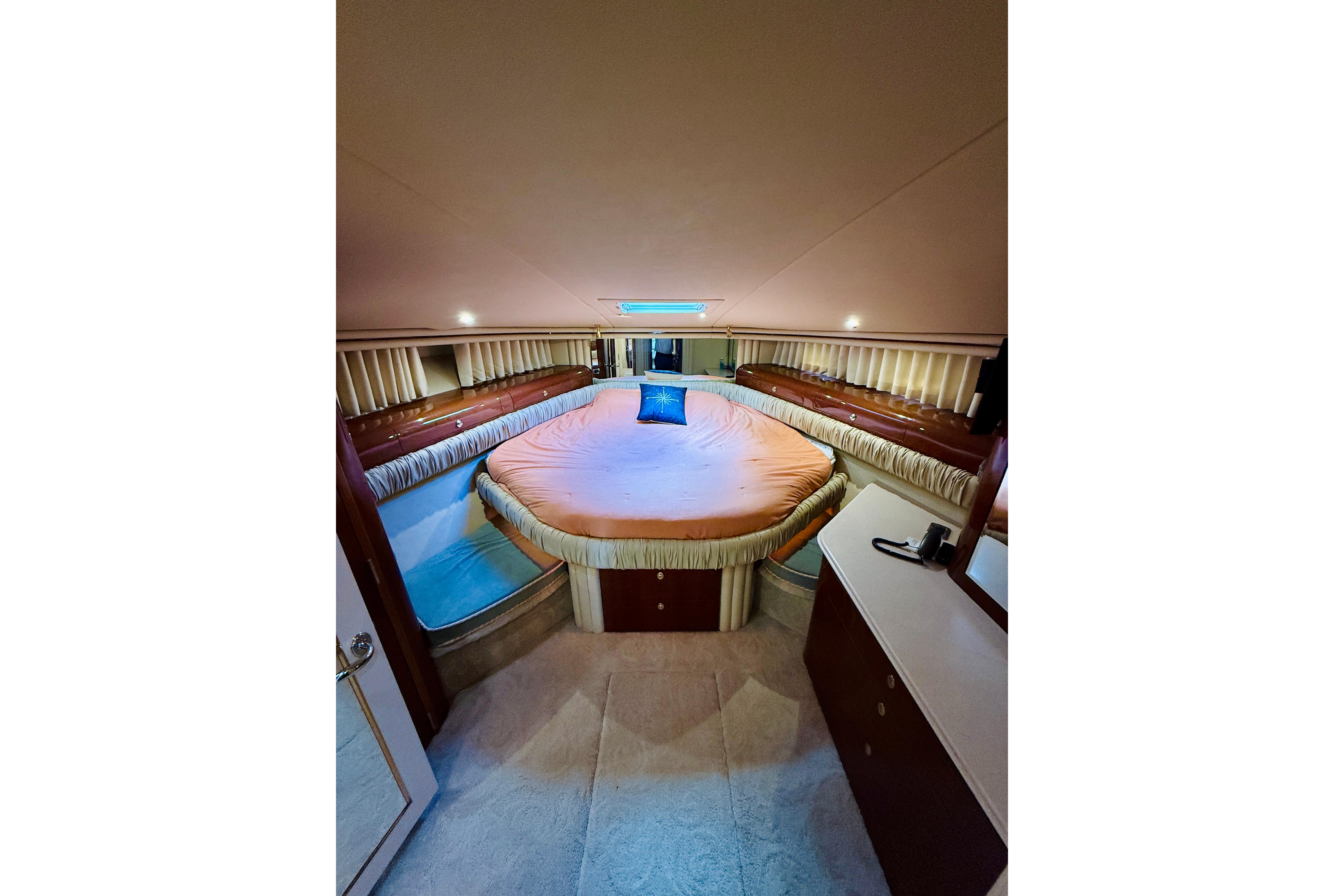 Luxurious 2003 Sea Ray 560 Sedan Bridge yacht bedroom interior with elegant bedding.