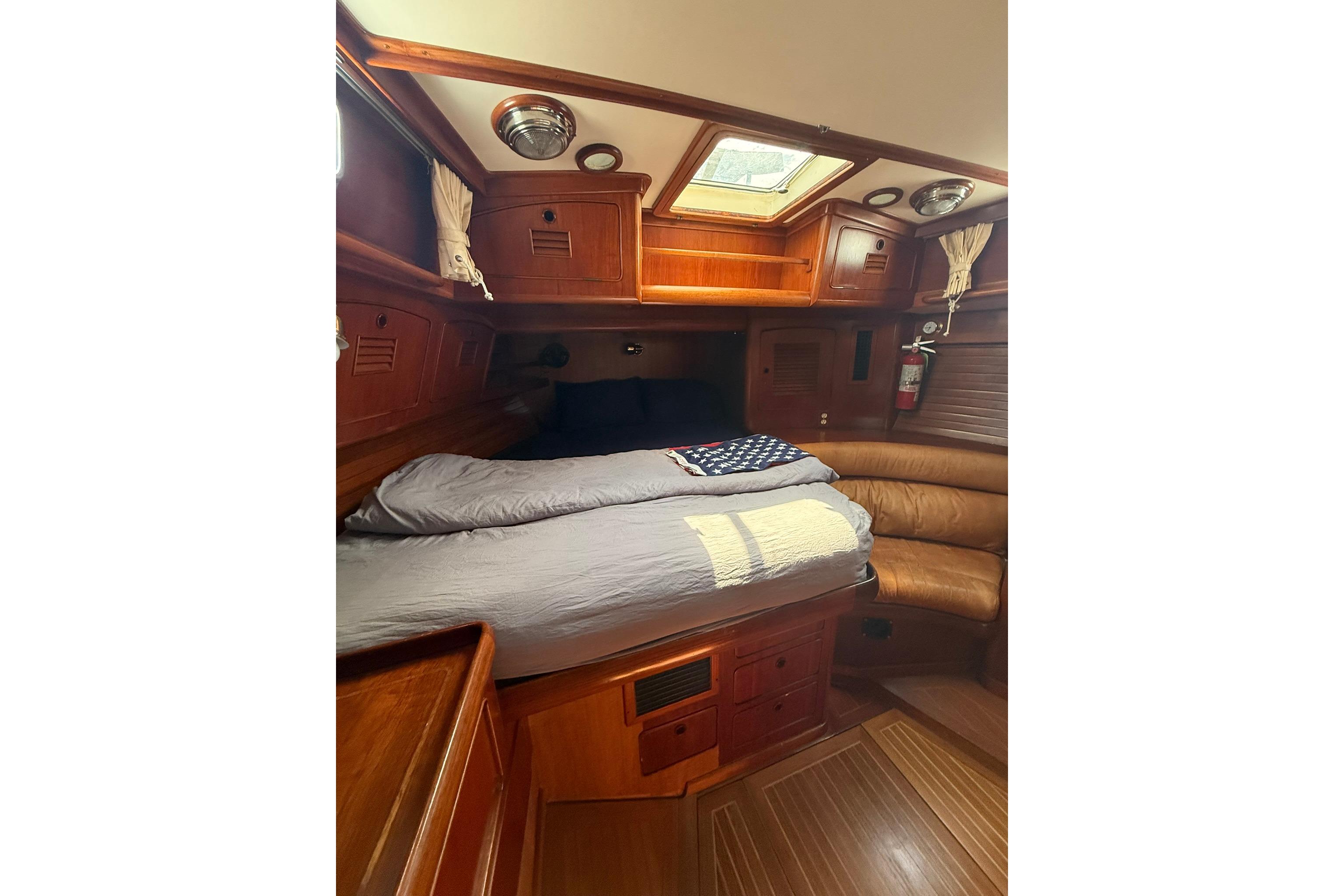 Cozy cabin interior of 1986 Little Harbor LH46 yacht with wooden furnishings and skylight.