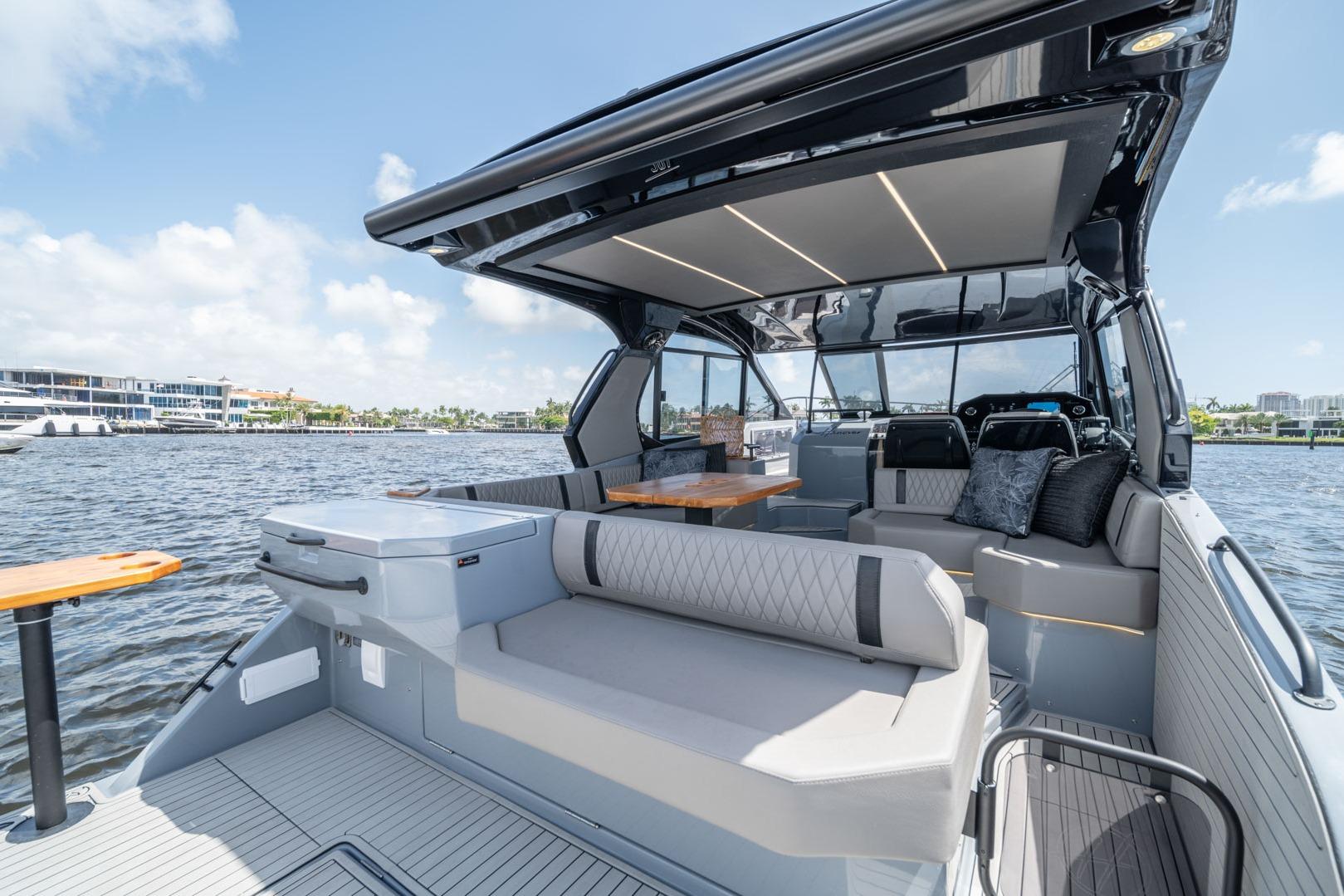 Luxurious 2026 Hanover 387 yacht interior with modern seating and sleek design on a sunny day.