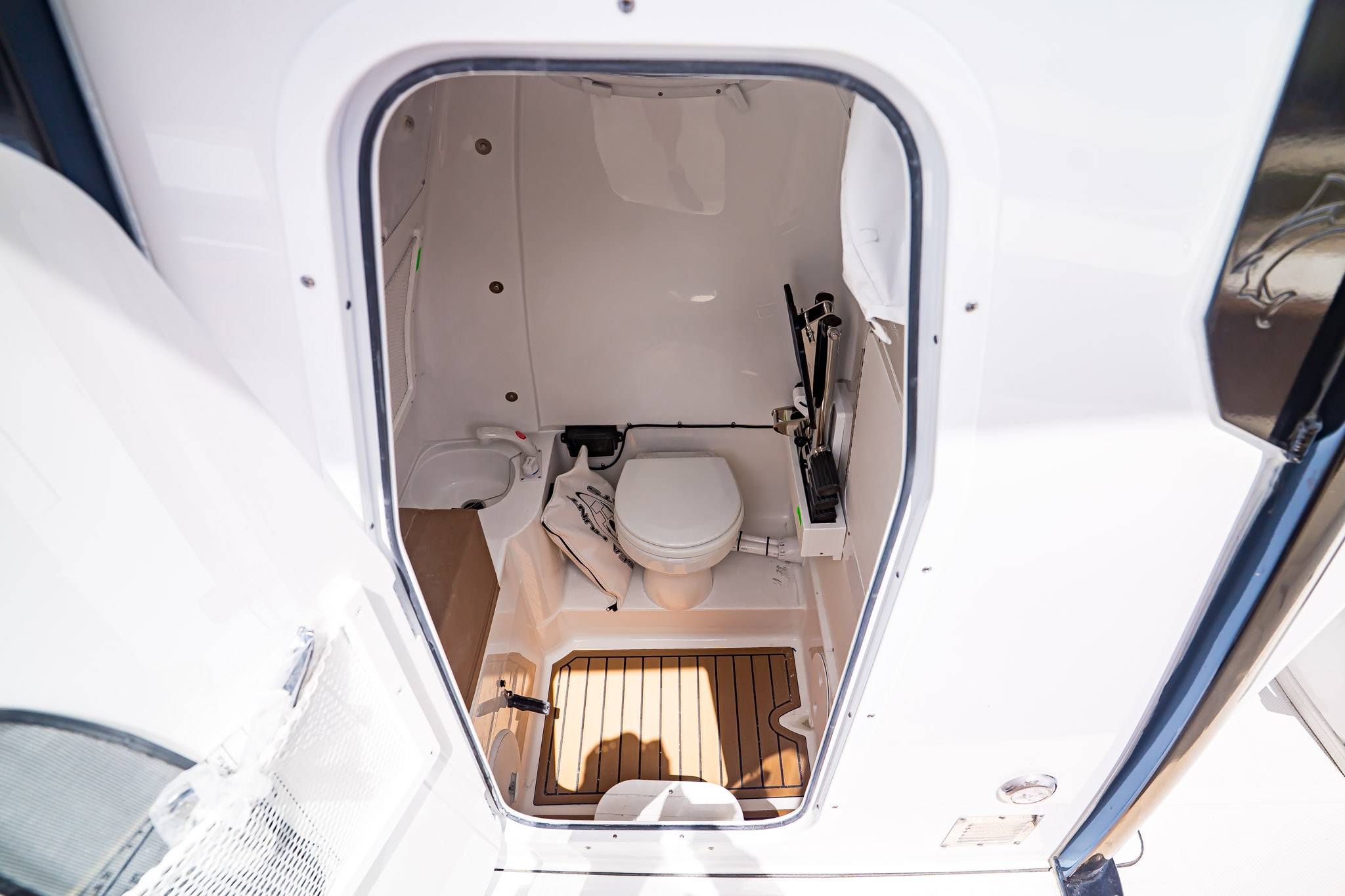 Interior view of Sea Hunt ULTRA 285CB 2026 boat toilet.