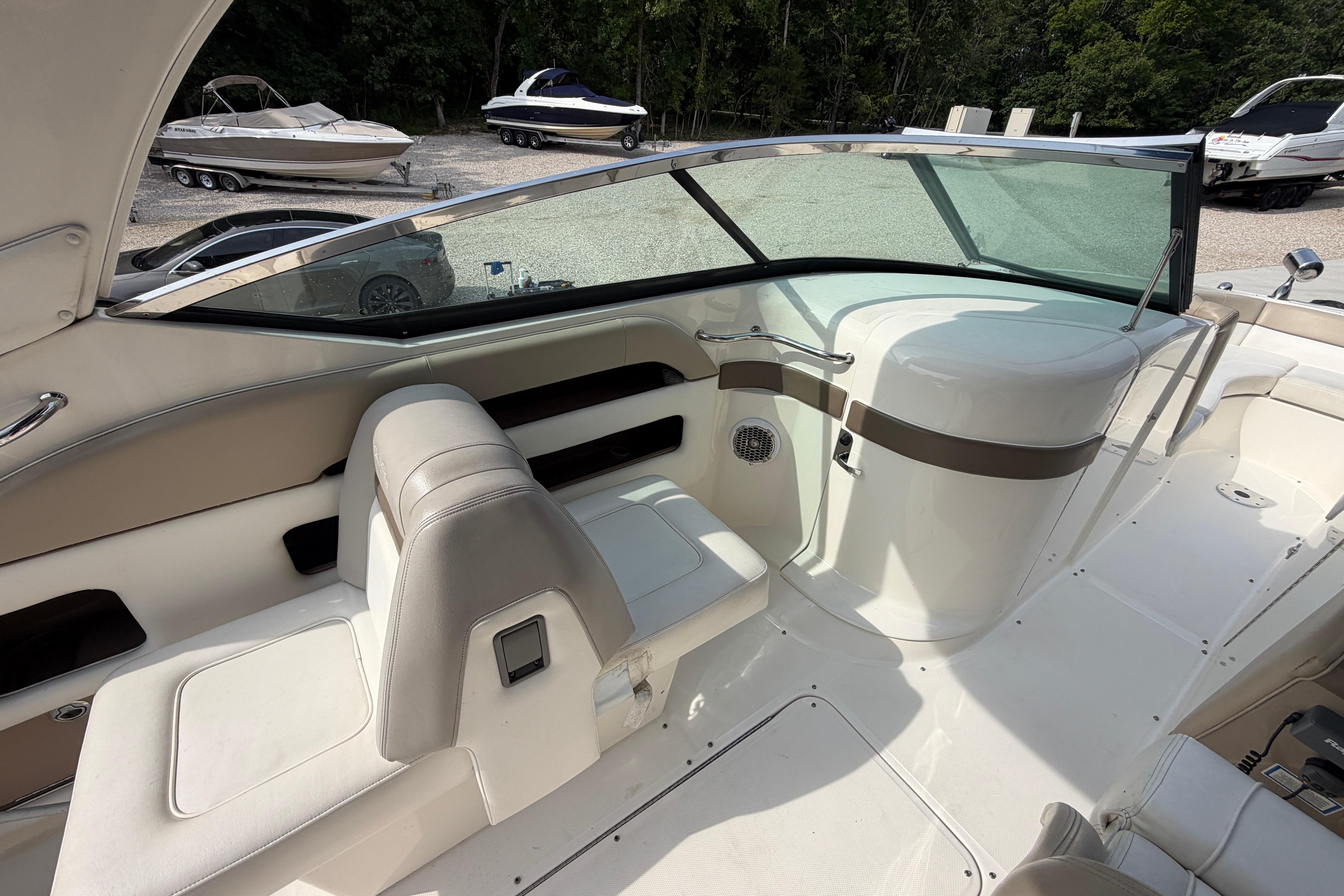 Interior of a 2013 Sea Ray 300 SLX boat with seating and dashboard view.