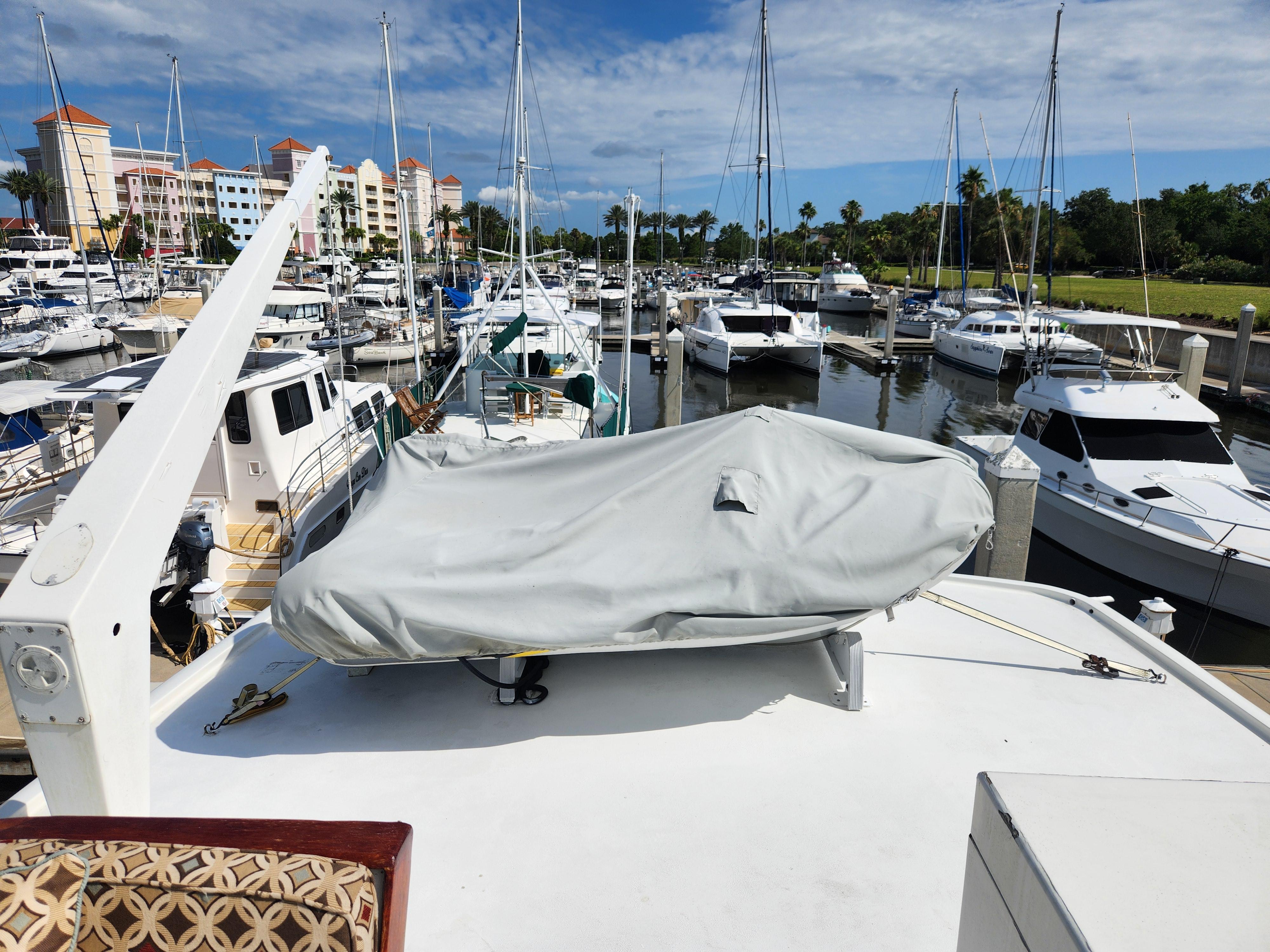 1979 Hatteras 58 Long Range Cruiser docked at a marina with other boats.