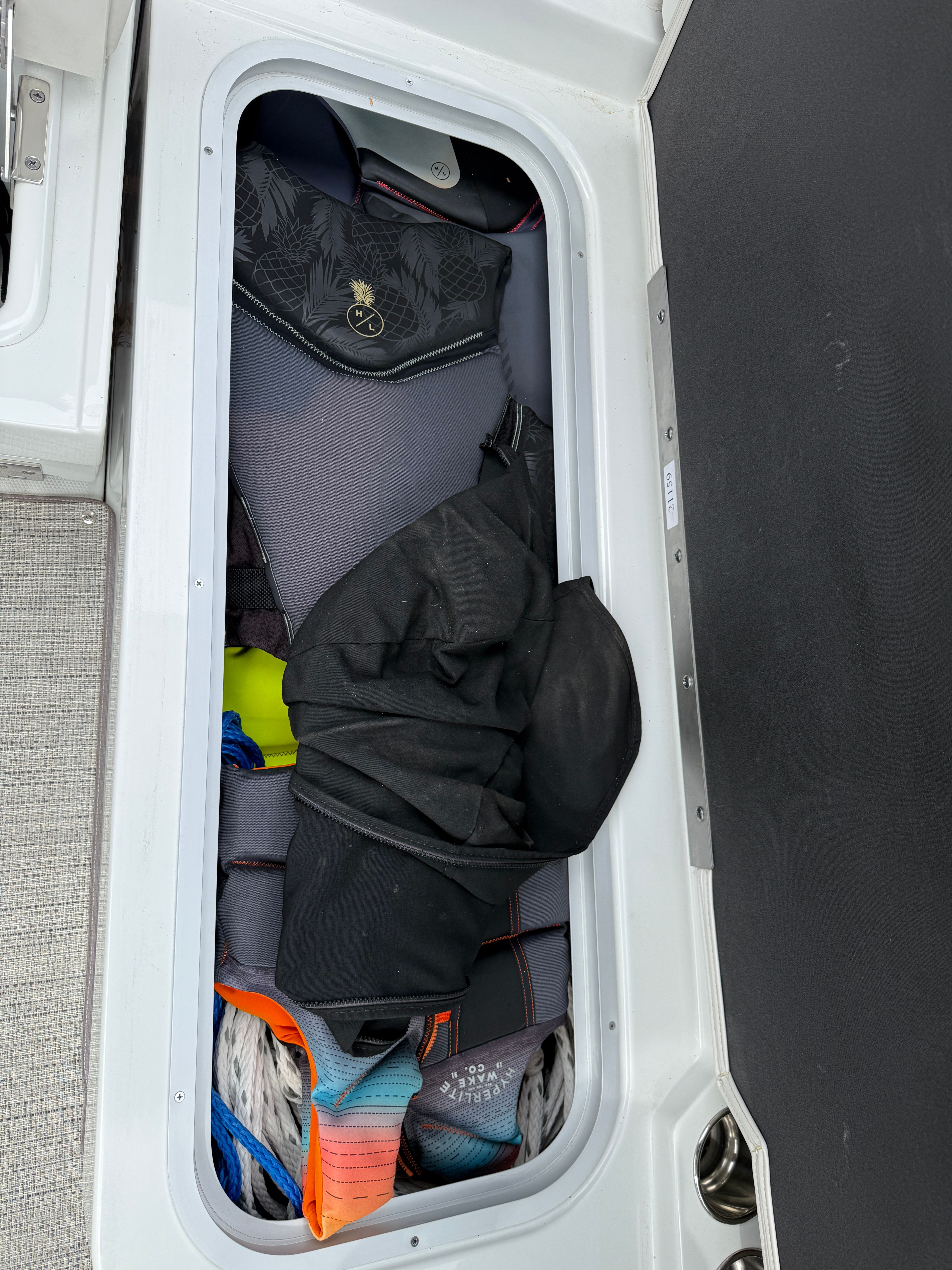 Storage compartment in Crownline 235 SS boat with gear.