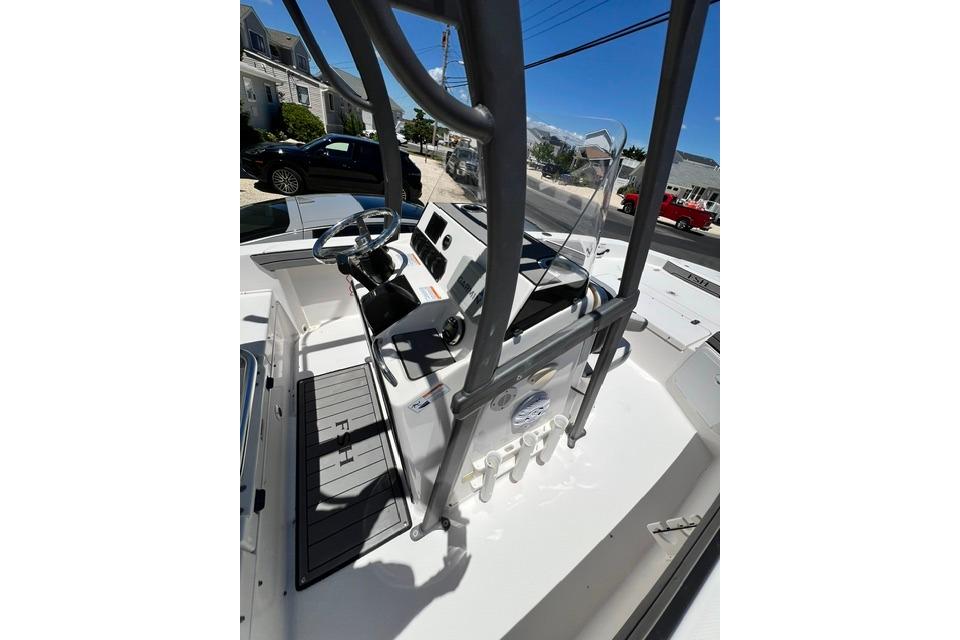2019 Yamaha Boats 190 FSH Sport interior with steering console and seating area.