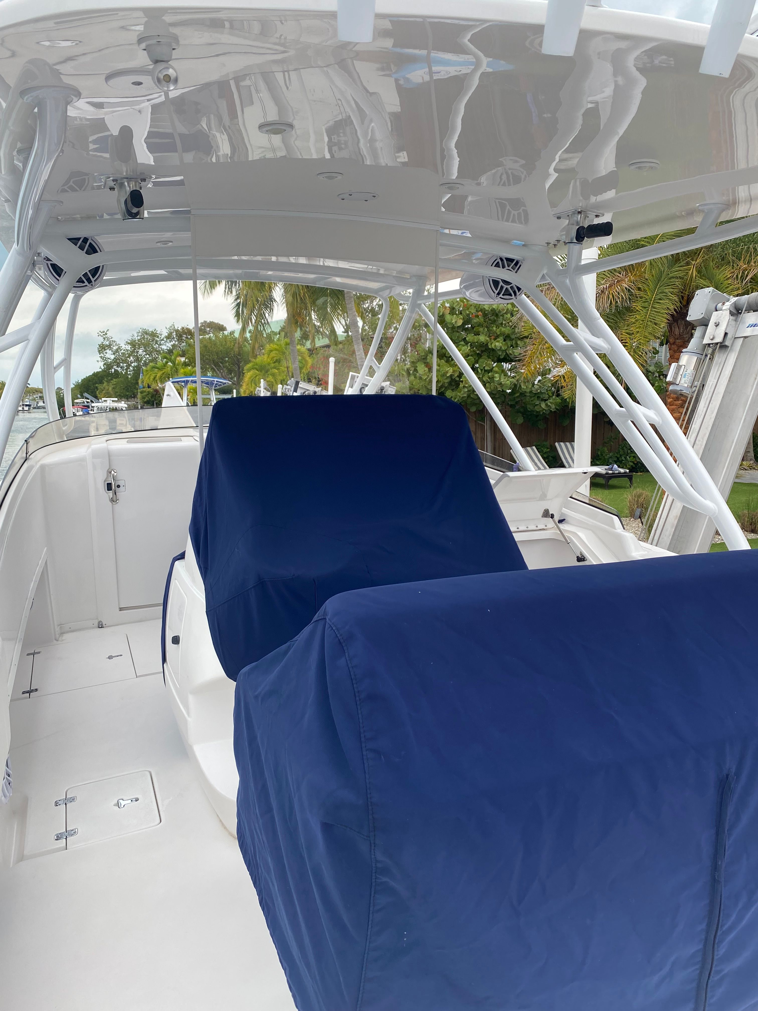 The image shows the cockpit of a 2011 Intrepid 37 boat with blue seat covers.
