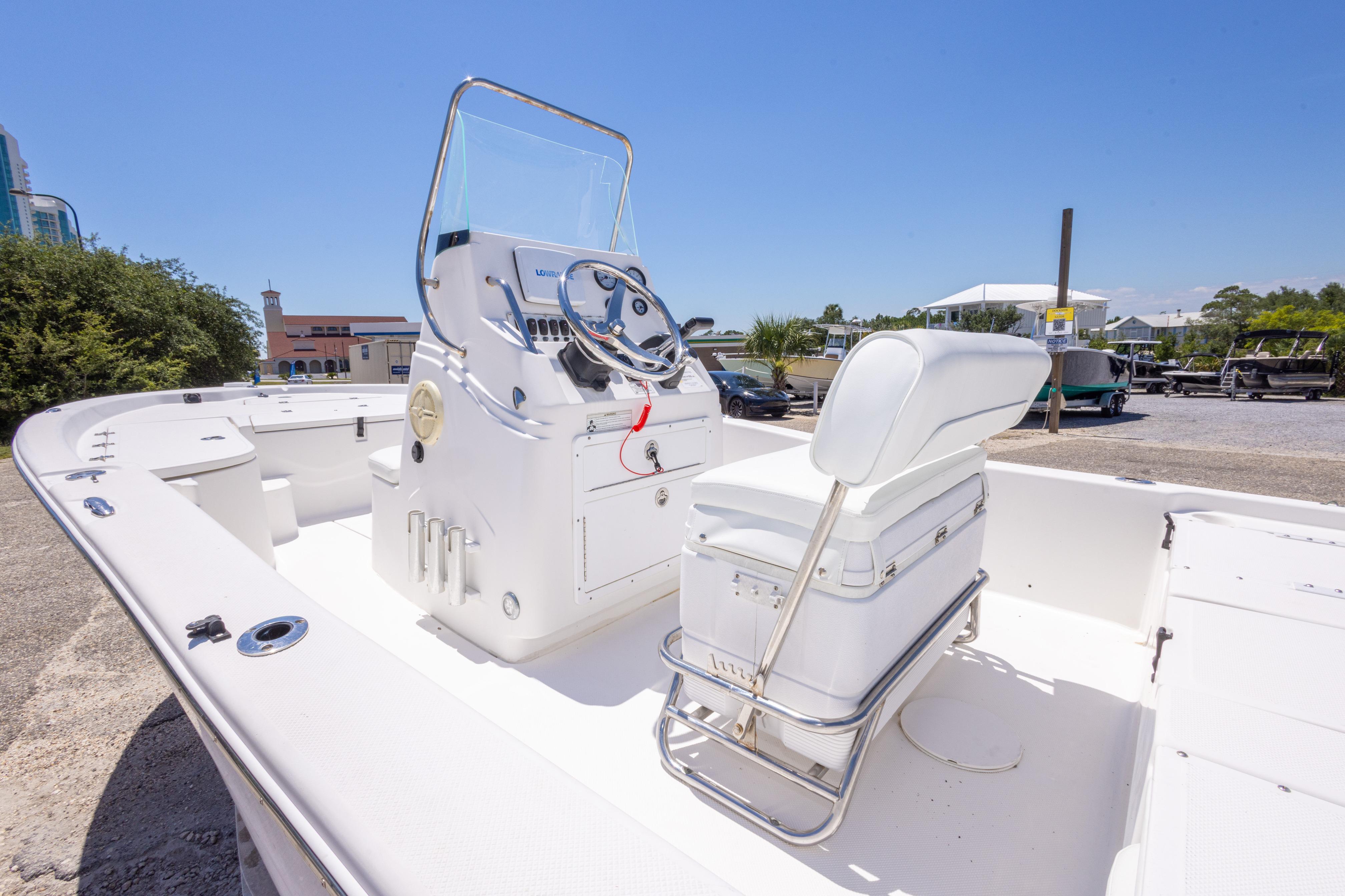 2011 Sea Fox 200XT boat with white interior and steering console, parked outdoors.