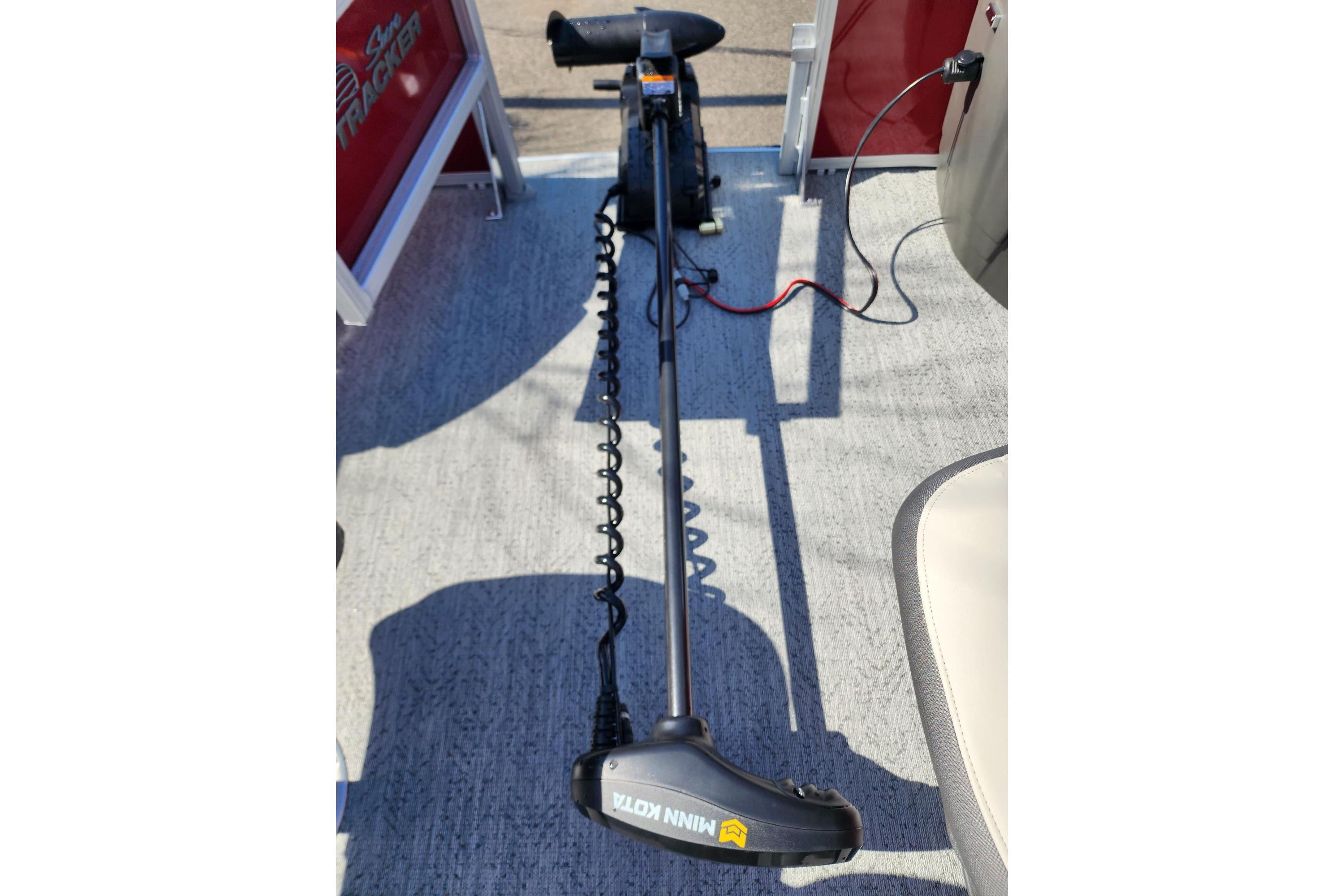 2026 Sun Tracker Fishin' Barge 22 DLX with Minn Kota trolling motor on deck.