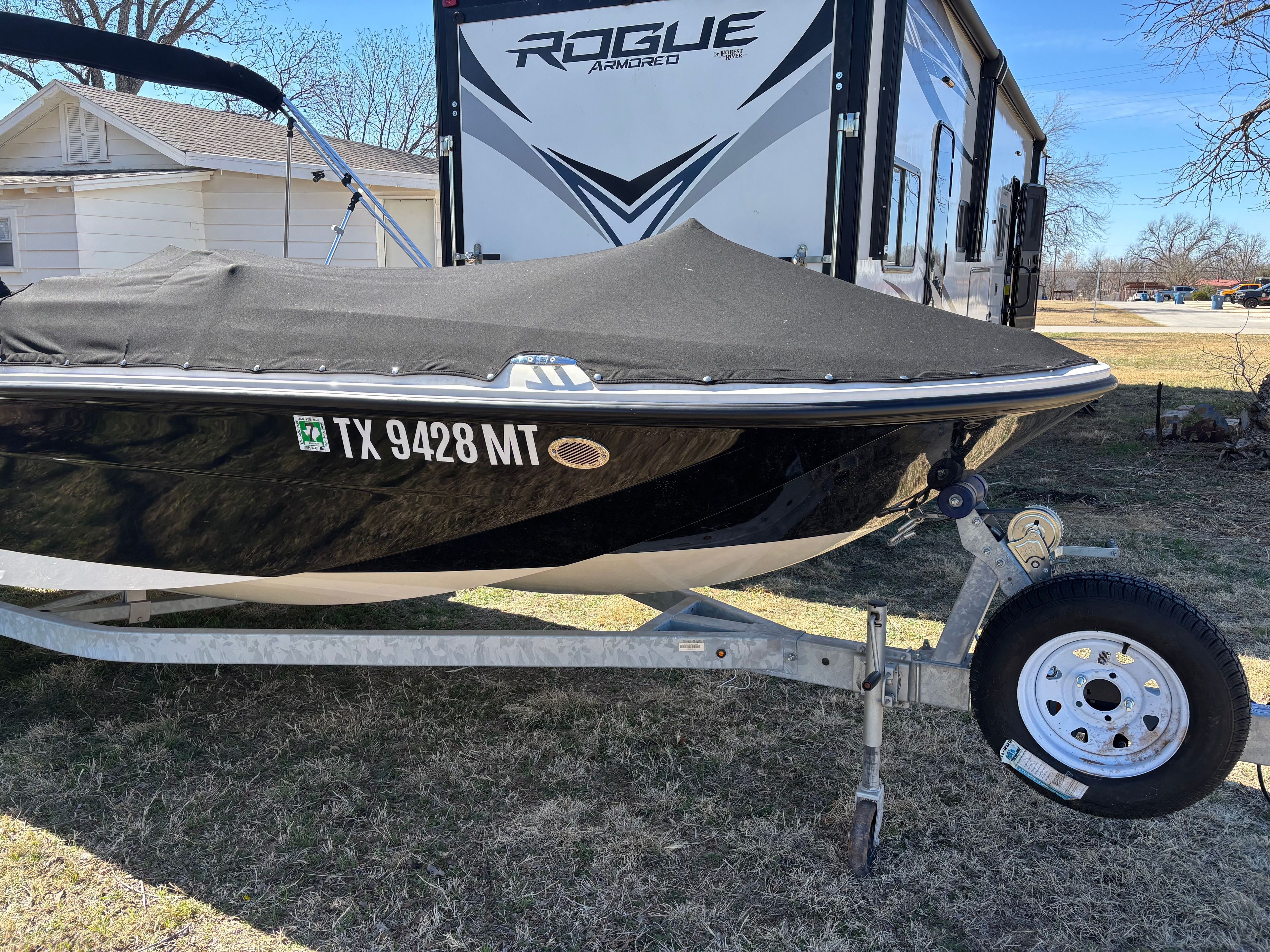 2025 Bayliner Element E18 boat covered on trailer.