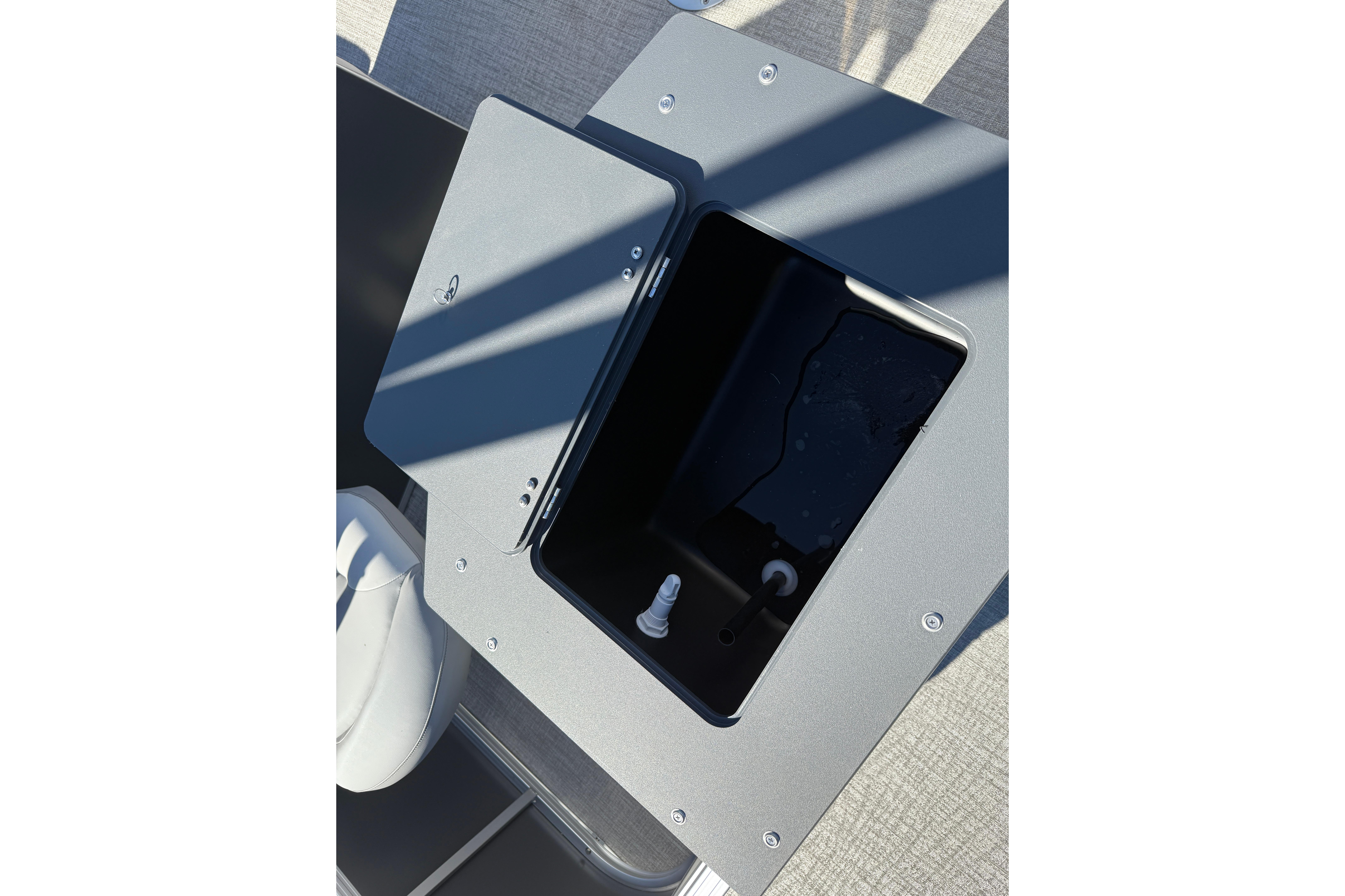 Open storage compartment on 2026 Avalon VENTURE 85 QUAD boat deck.