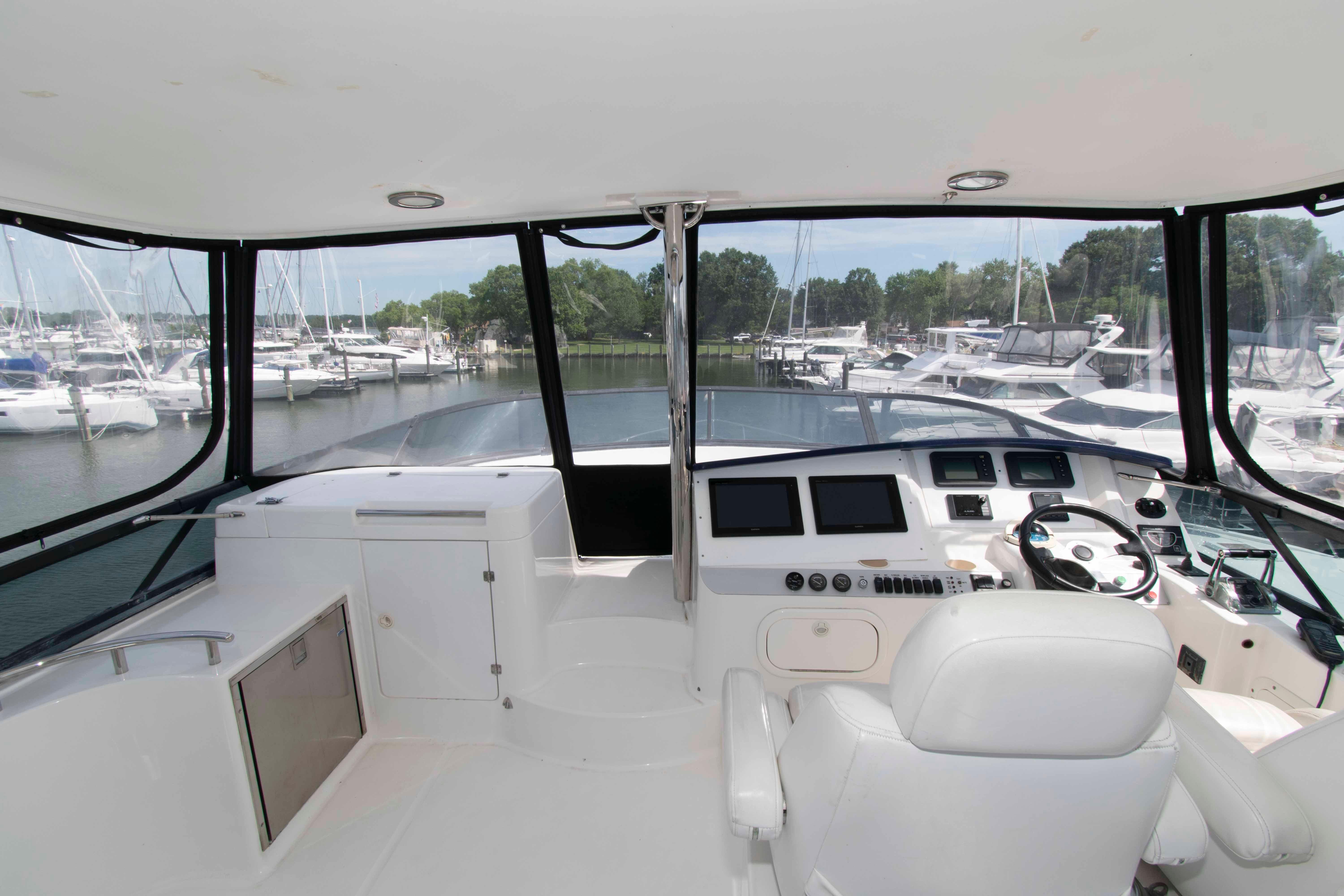 Flybridge helm of 2003 Neptunus 56 yacht with marina view.