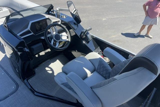 2024 Manitou 25 LX SRW boat interior with modern steering and seating.