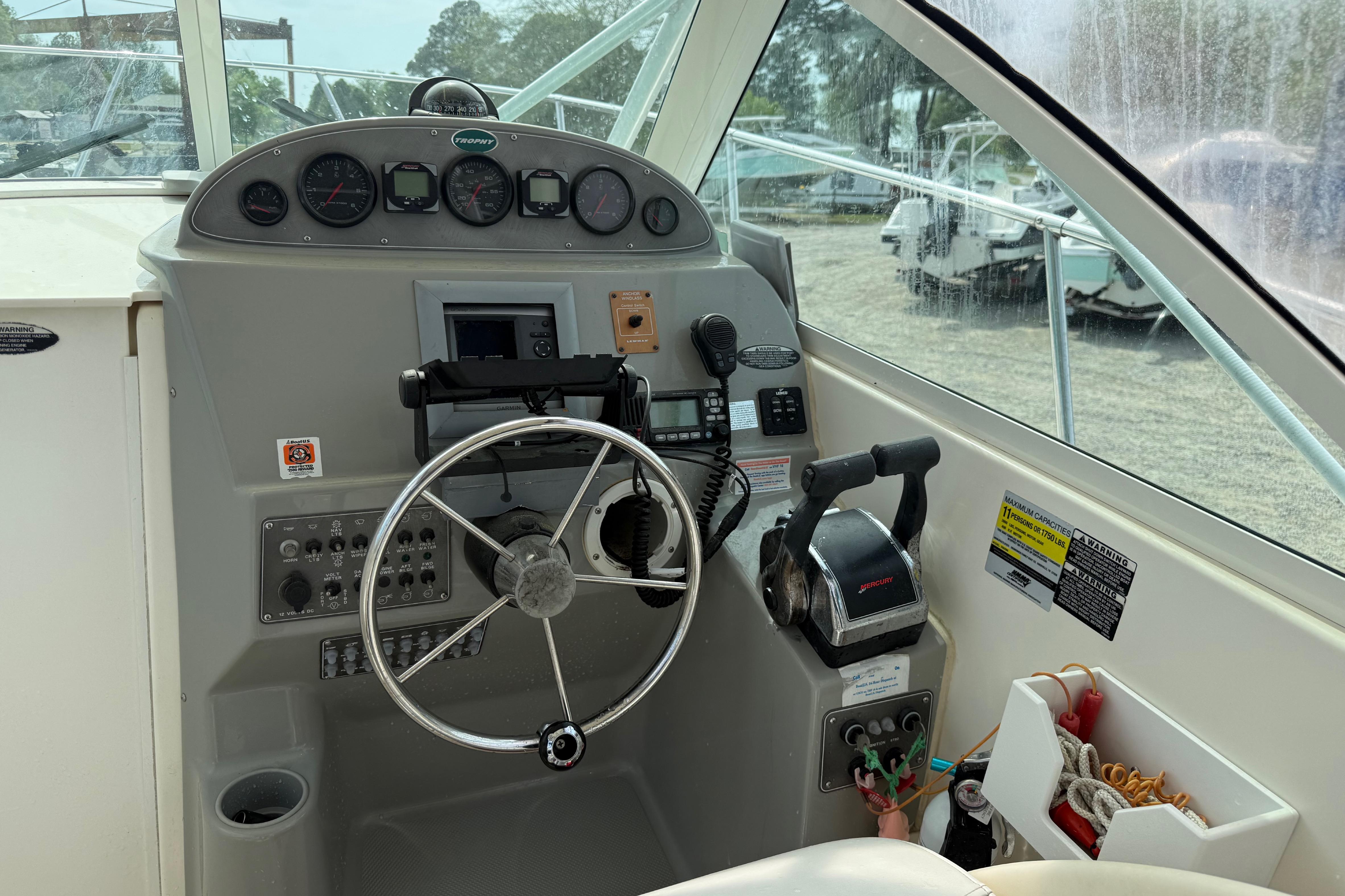 2006 Trophy 2502 Walkaround boat dashboard with steering wheel and controls.