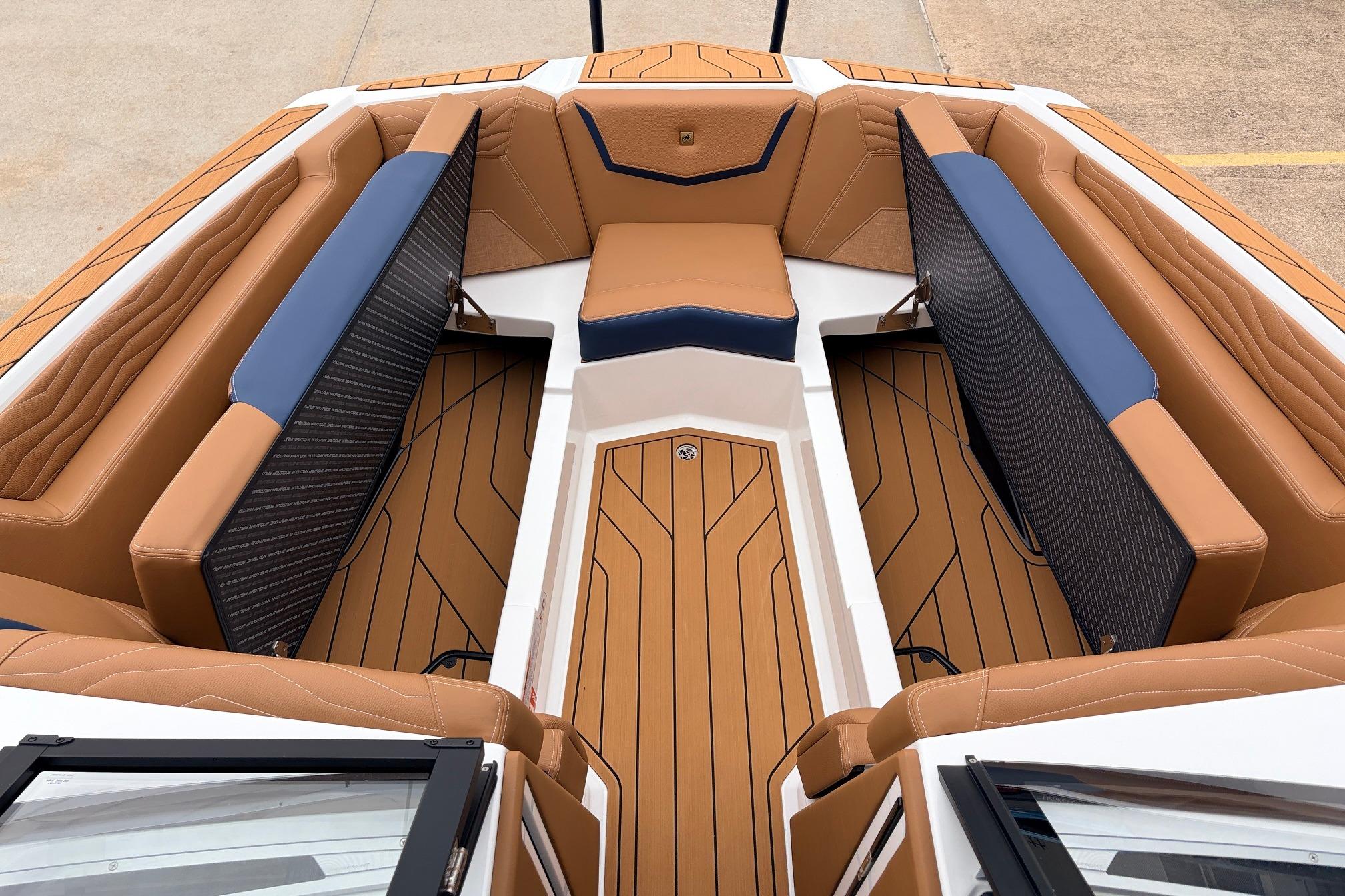 Luxurious interior of 2026 Nautique Super Air Nautique G25 boat with tan and blue seating.