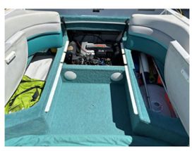 Interior view of a 1993 Chris-Craft 238 Cuddy Concept boat with seating and engine.