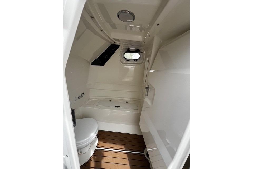 Interior of 2022 Brig Eagle 8 boat, featuring a compact, modern bathroom with wooden flooring.