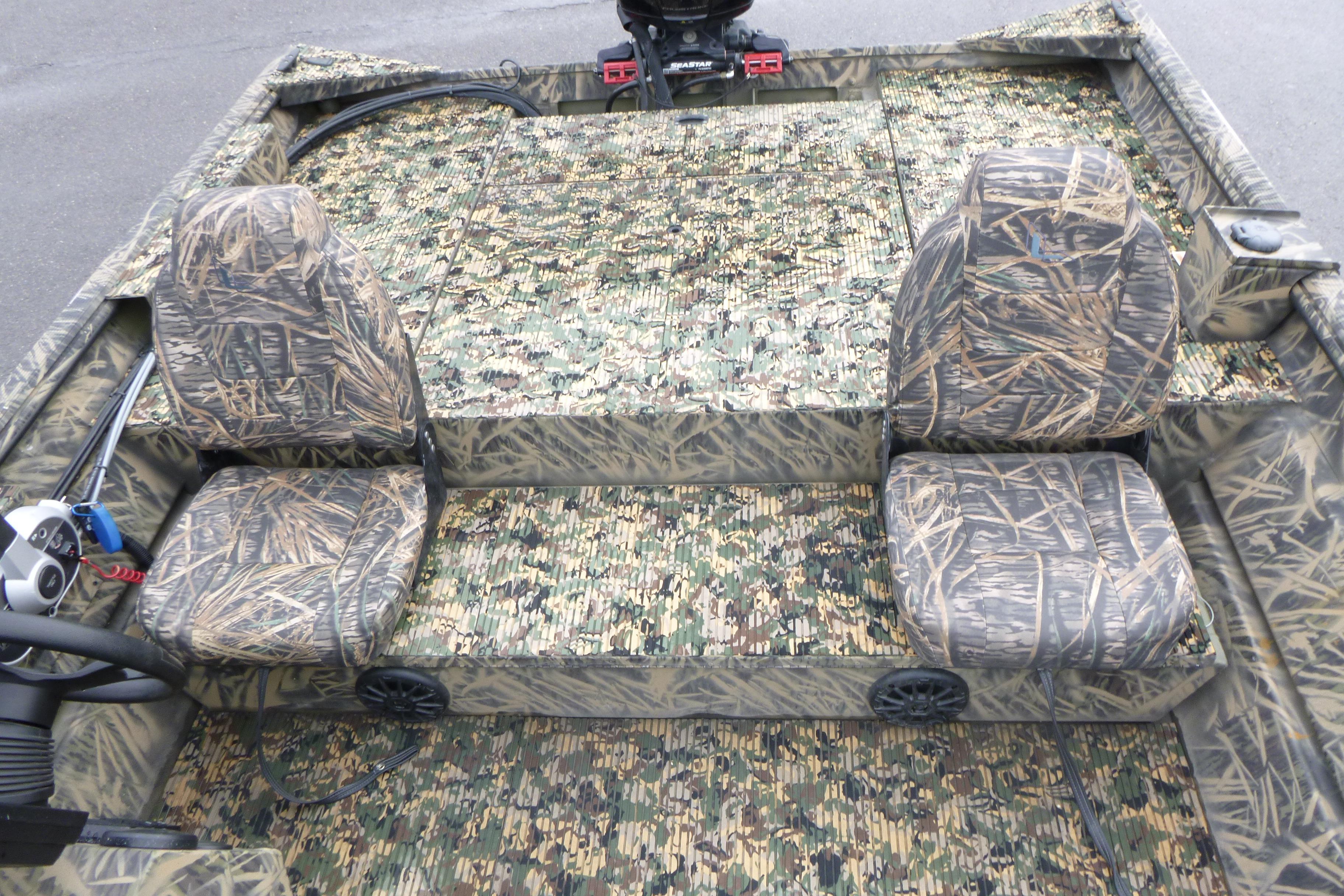 2024 Lowe Roughneck 2070 boat interior with camouflage seating and flooring design.