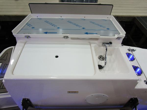 2025 Cutwater C-248 Coupe boat deck with storage compartment and sink.