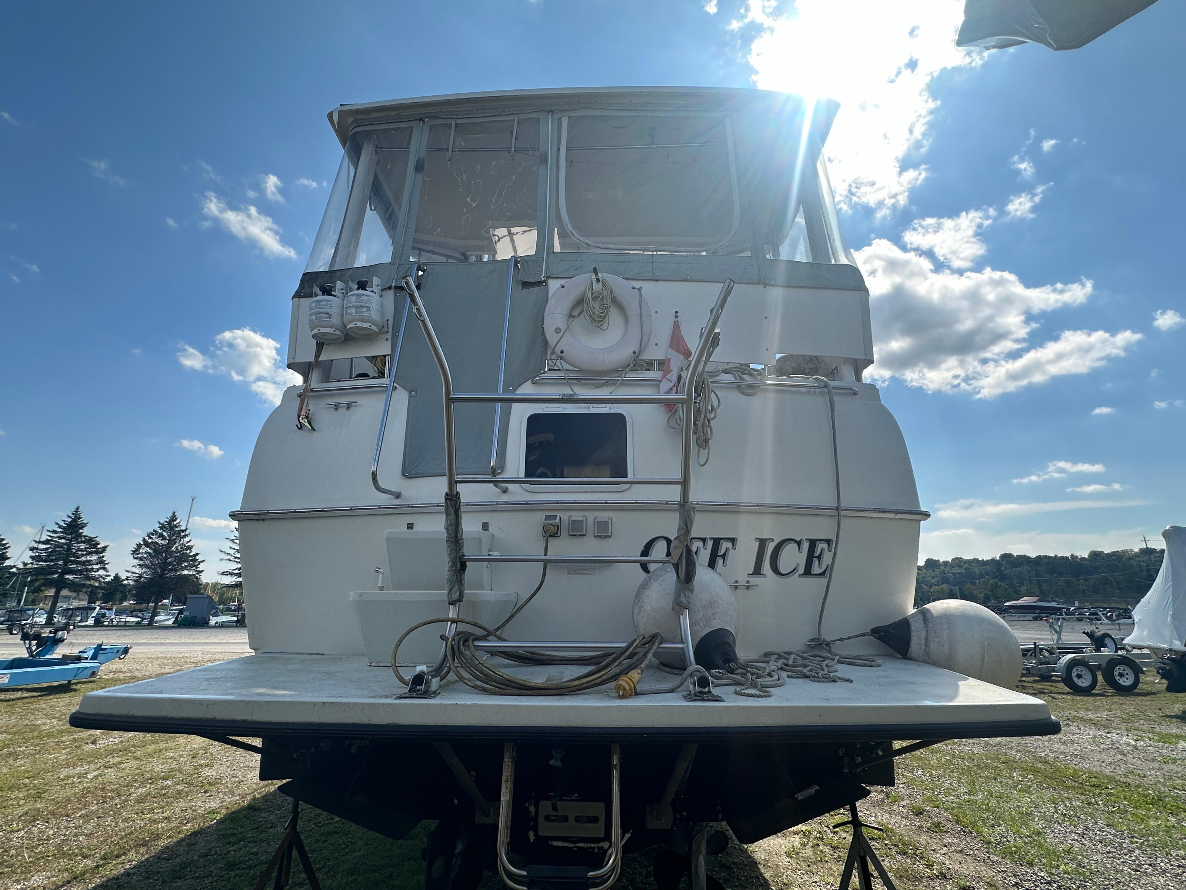 1994 Silverton 34 Aft Cabin Motor Yacht on land, rear view, sunny day.