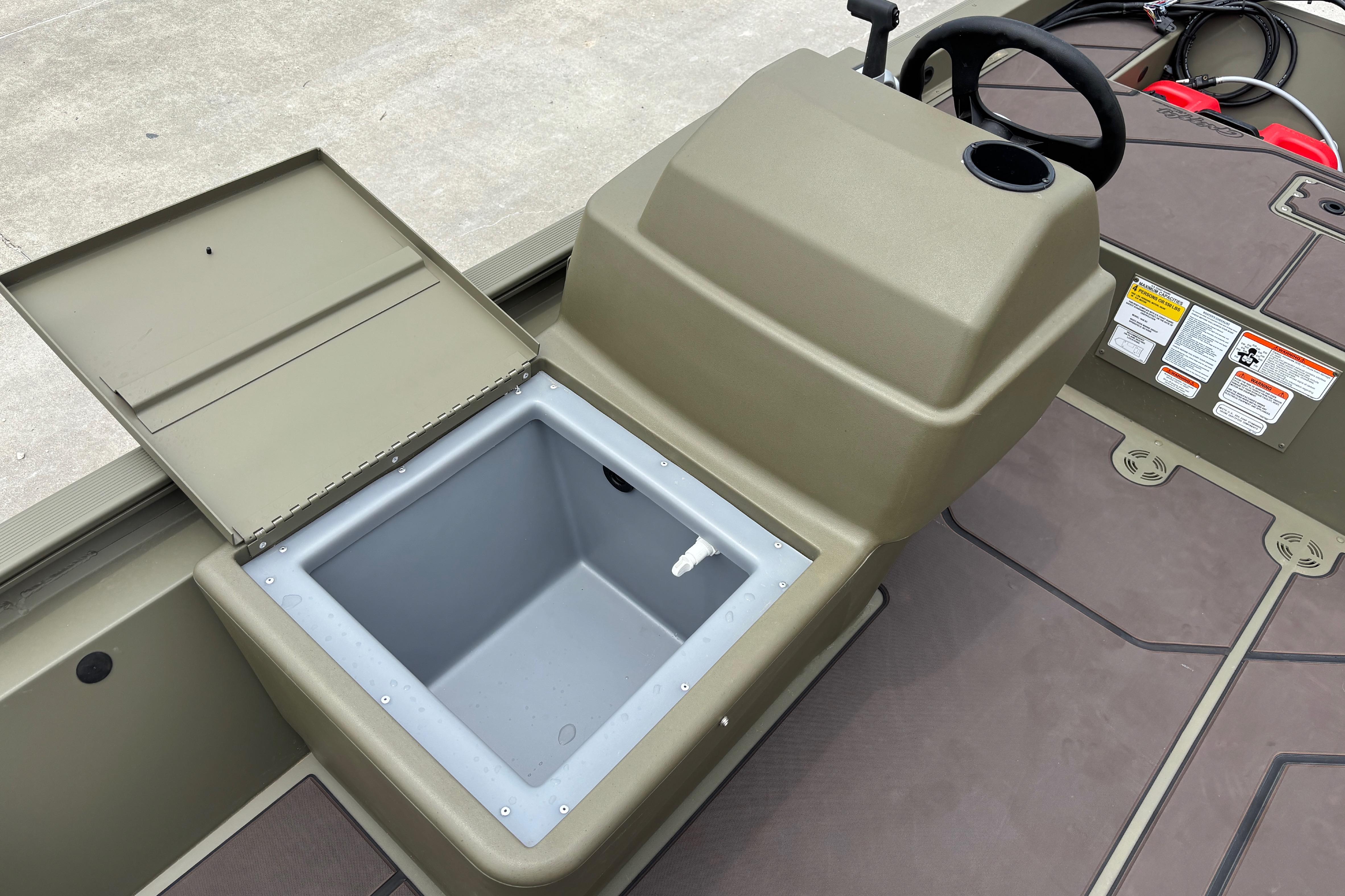 2026 Tracker Grizzly 1648 SC boat interior with open storage compartment and steering console.