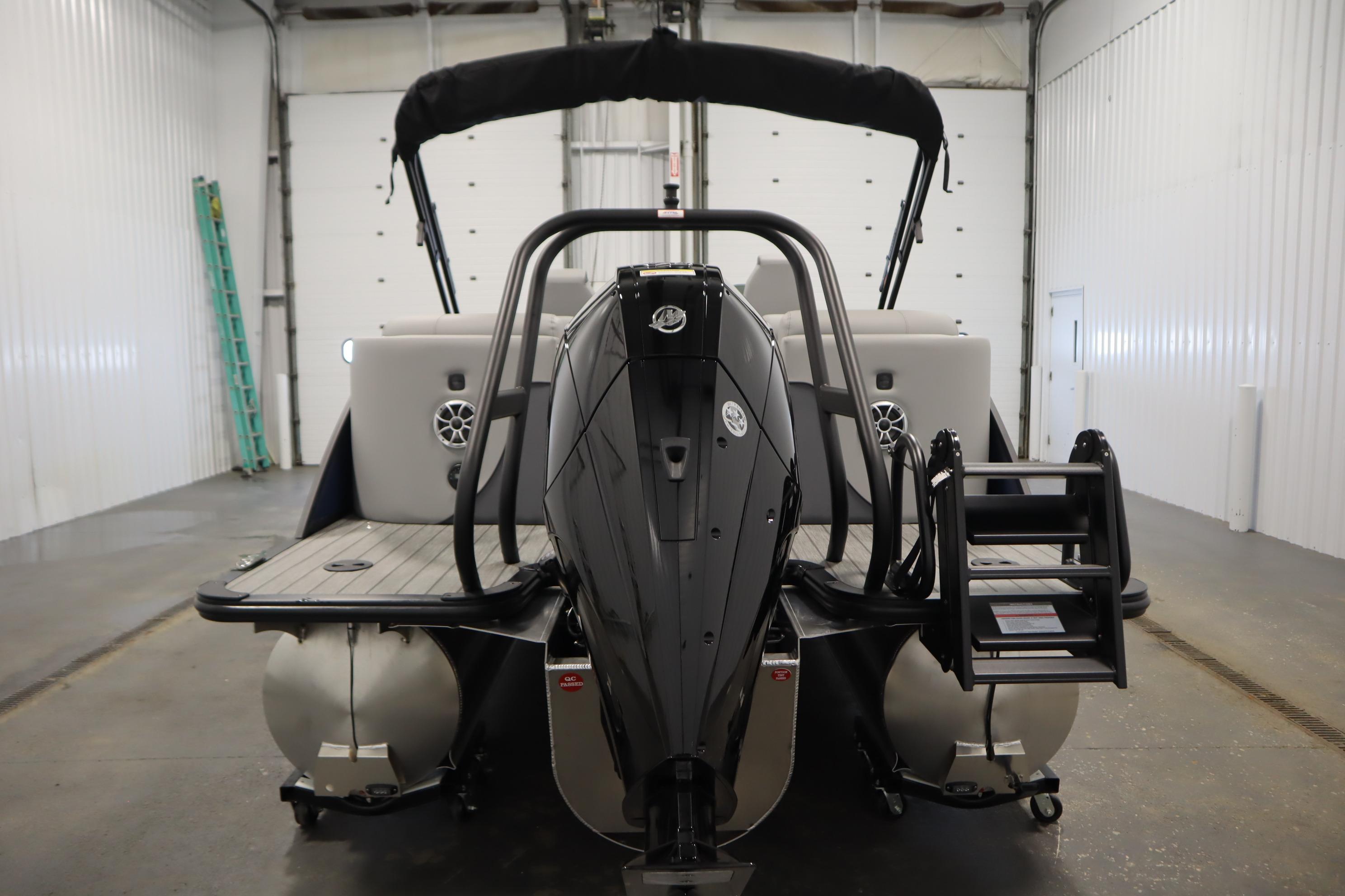 2025 Bentley Pontoons Elite 253 Admiral Tri-toon in a garage, rear view.
