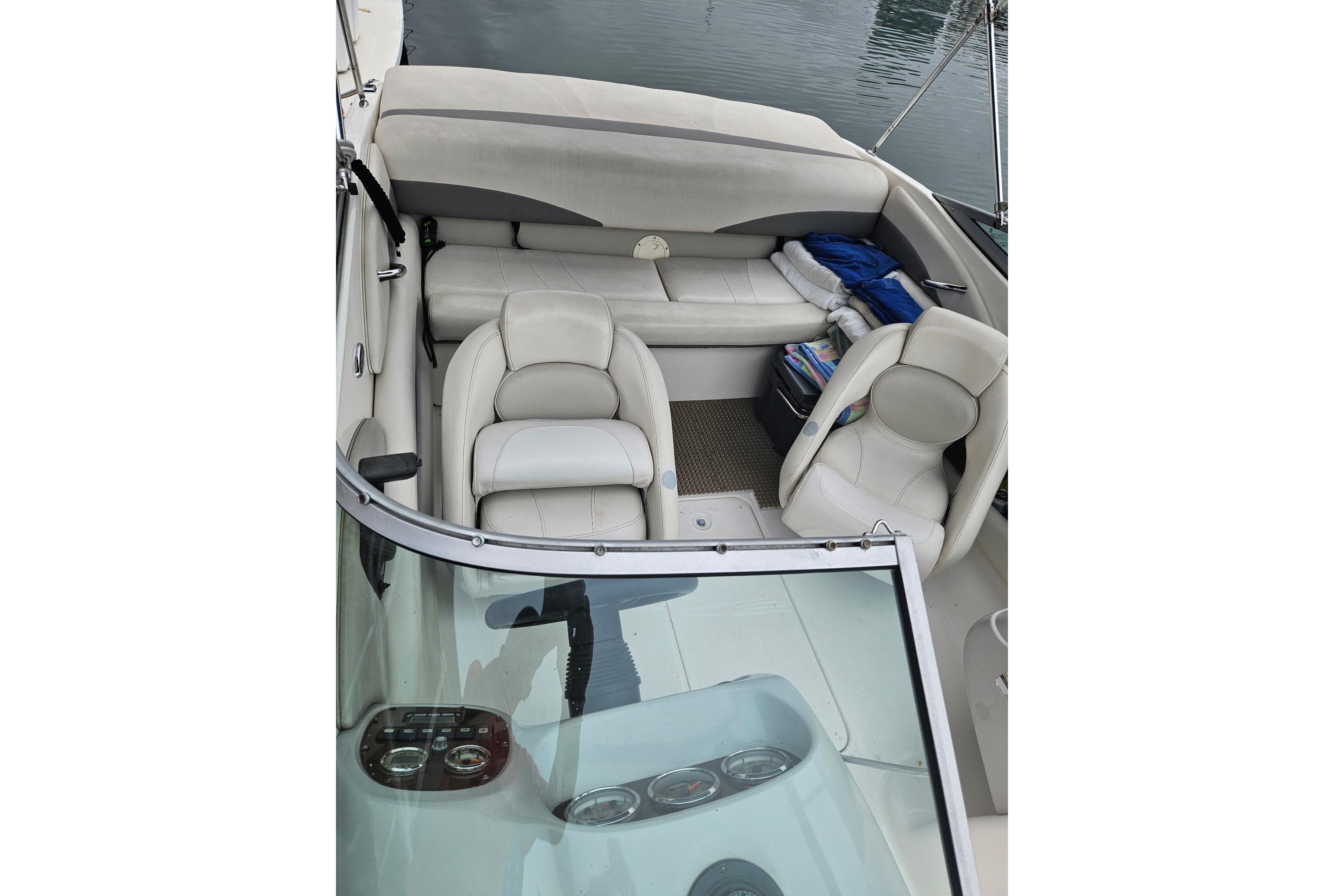 2006 Chaparral 190 SSi boat interior with white seating and dashboard view.