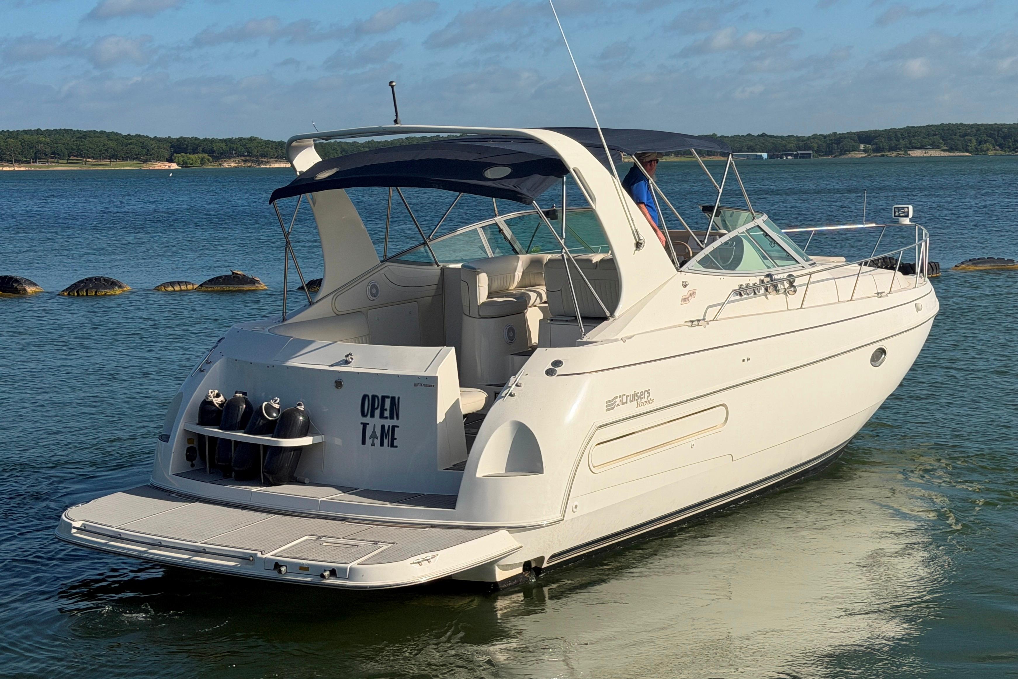 1997 Cruisers 3575 yacht on calm water, featuring a sleek design and spacious deck.
