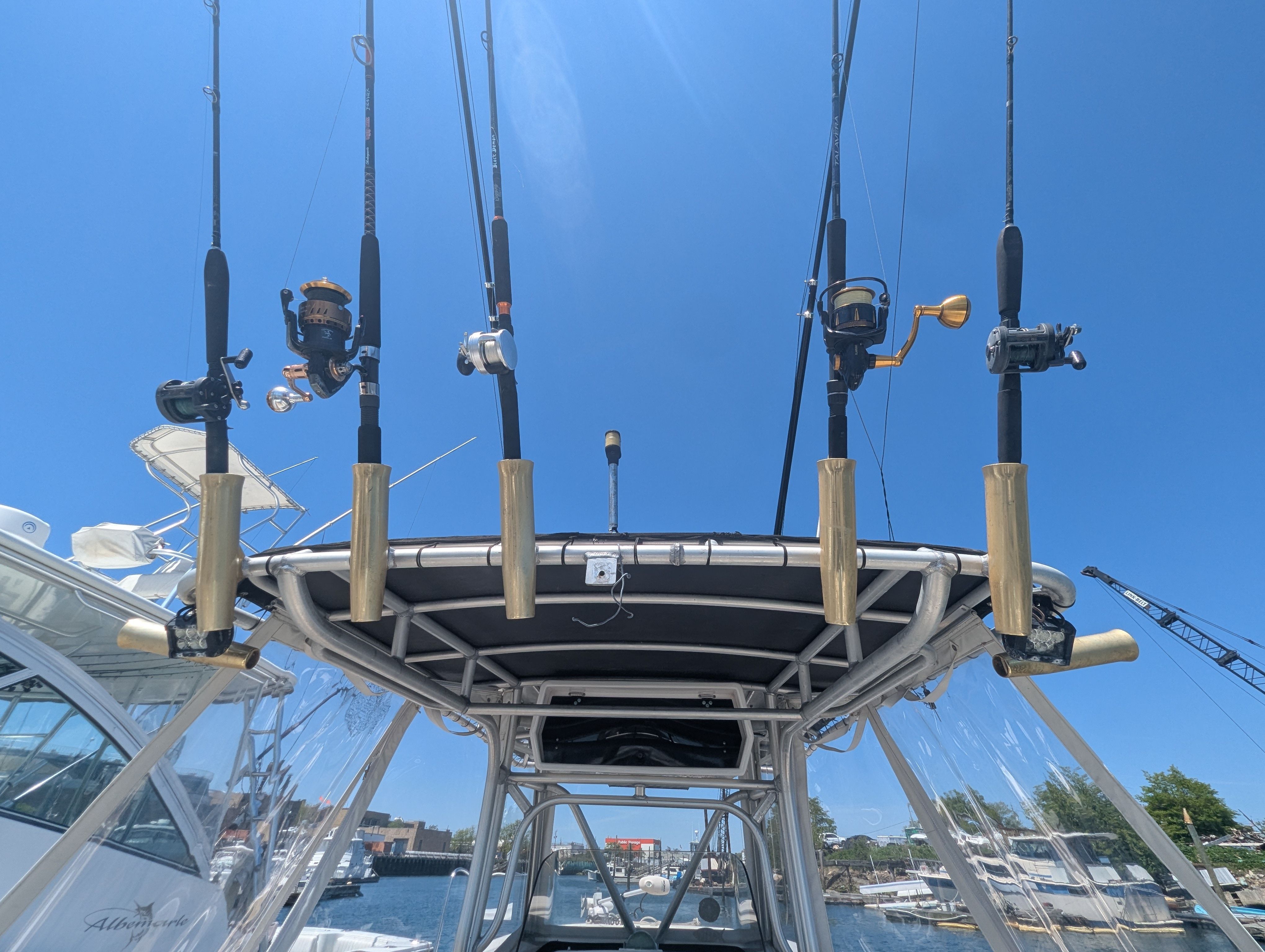 Fishing rods on a 2005 Wellcraft 35 CCF boat under blue sky.