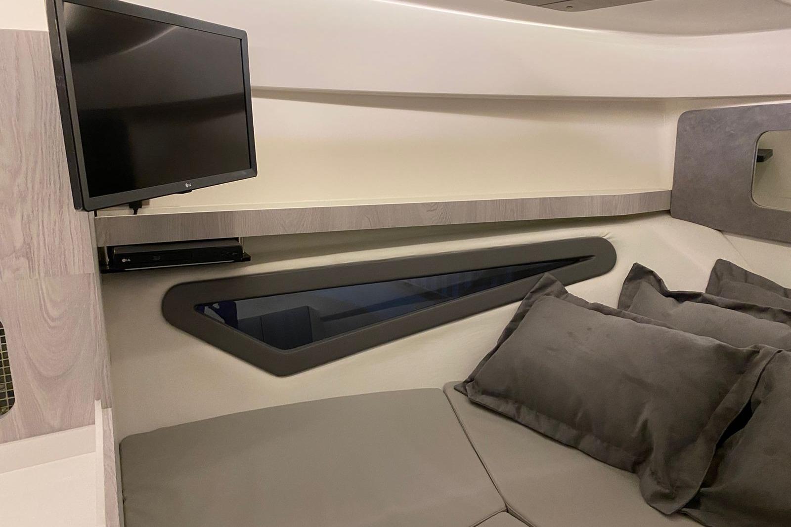 Interior of 2026 Hanover 375 yacht with TV and plush seating.