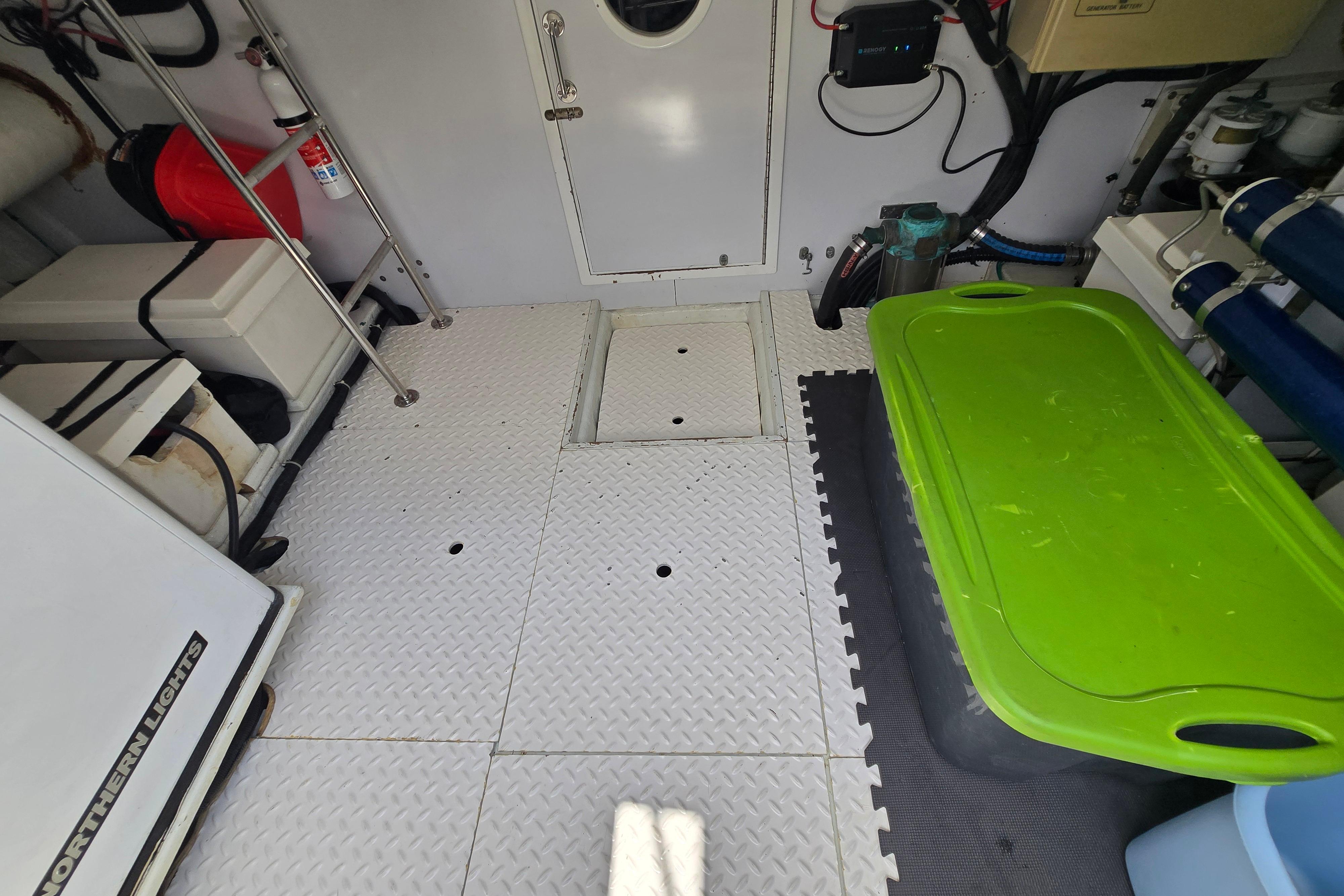 Engine room of a 2004 Grand Harbour 58 yacht with equipment and storage.