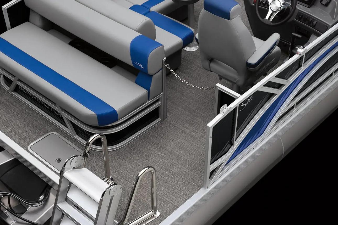 2026 Bennington S 20 SSR pontoon boat interior with gray and blue seating, steering console, and ladder.