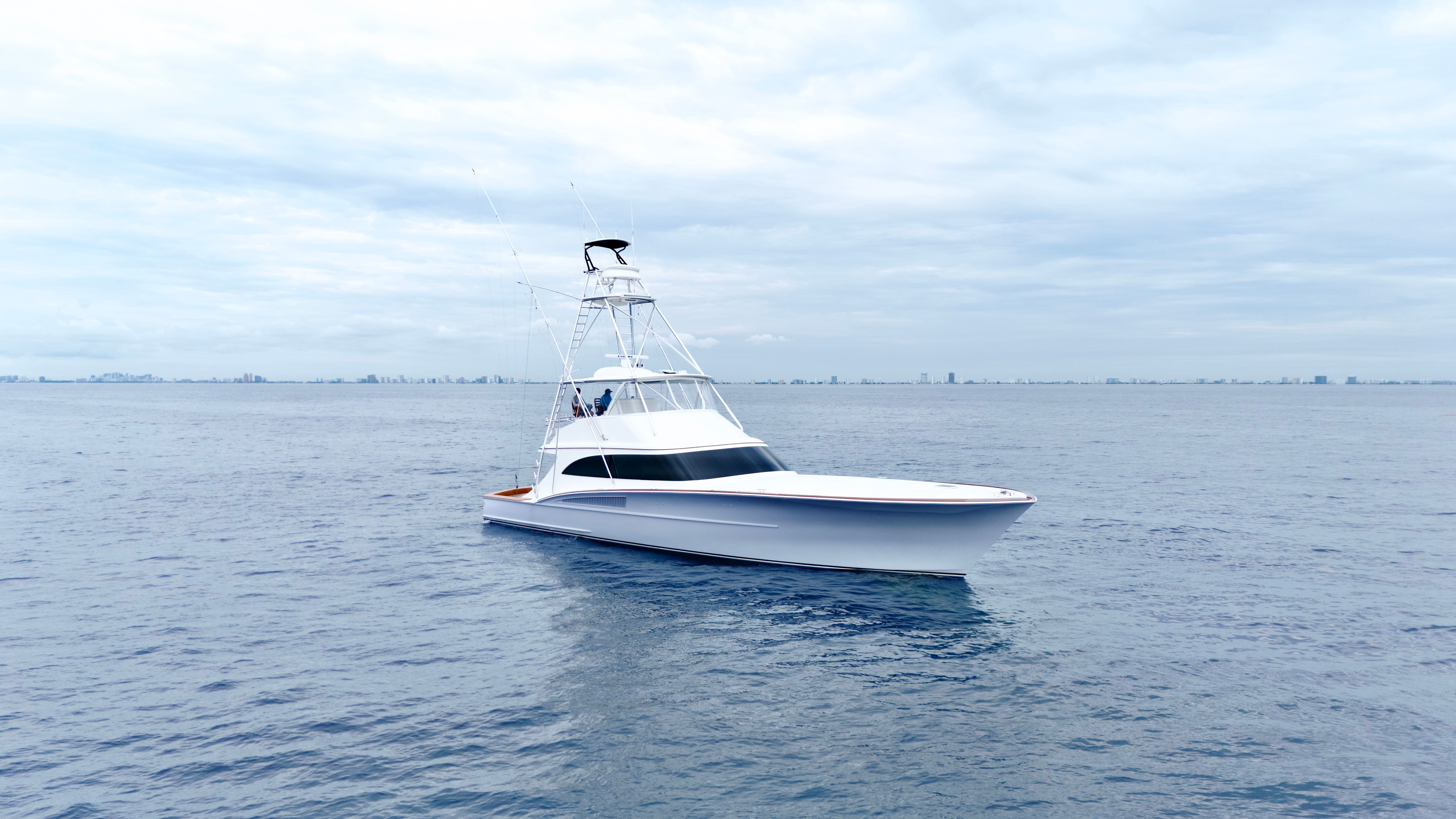 A sleek 2025 Titan Yachts sportfish boat on calm waters.
