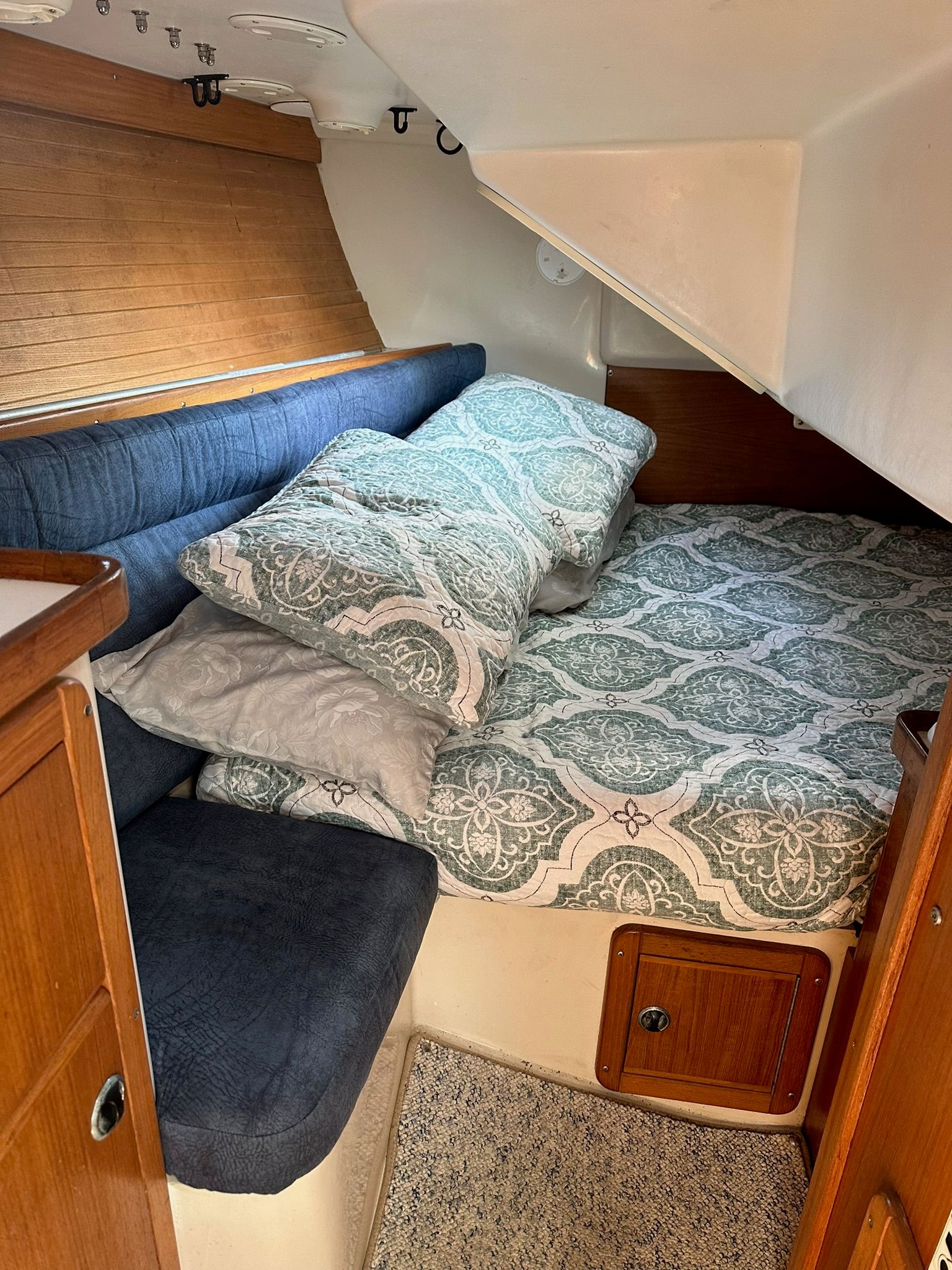 Interior of a Catalina MkII with a cozy bed and wooden furnishings.