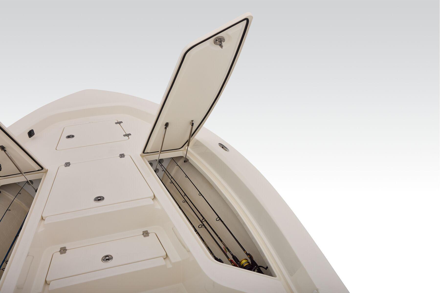 2026 Mako 24 APEX boat storage compartments with open hatches, showcasing ample space.