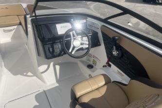 2017 Sea Ray SPX 210 Outboard boat interior with steering wheel and seating.