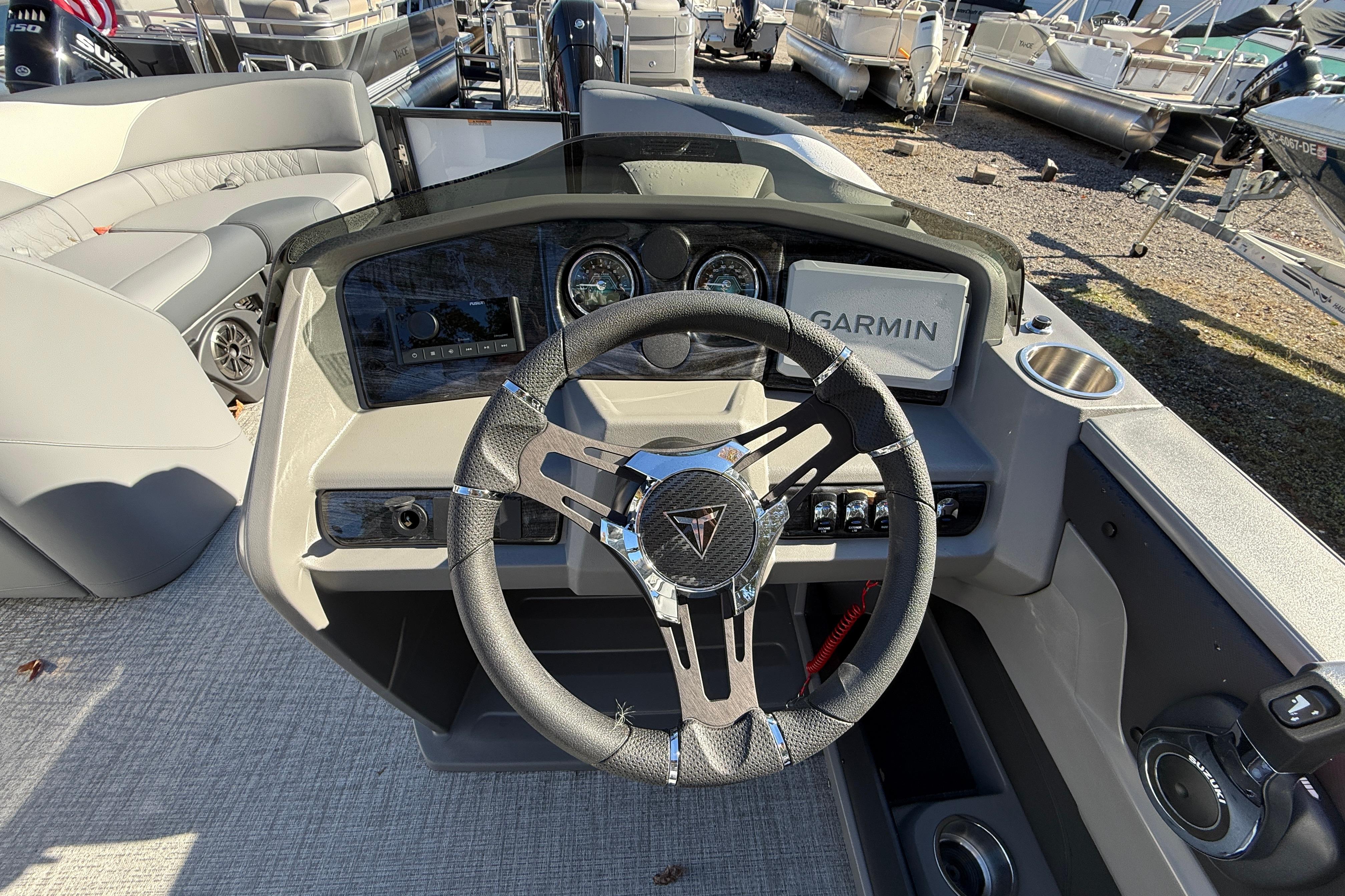 2026 Tahoe Pontoon LTZ Quad Lounger dashboard with Garmin navigation and modern steering wheel.