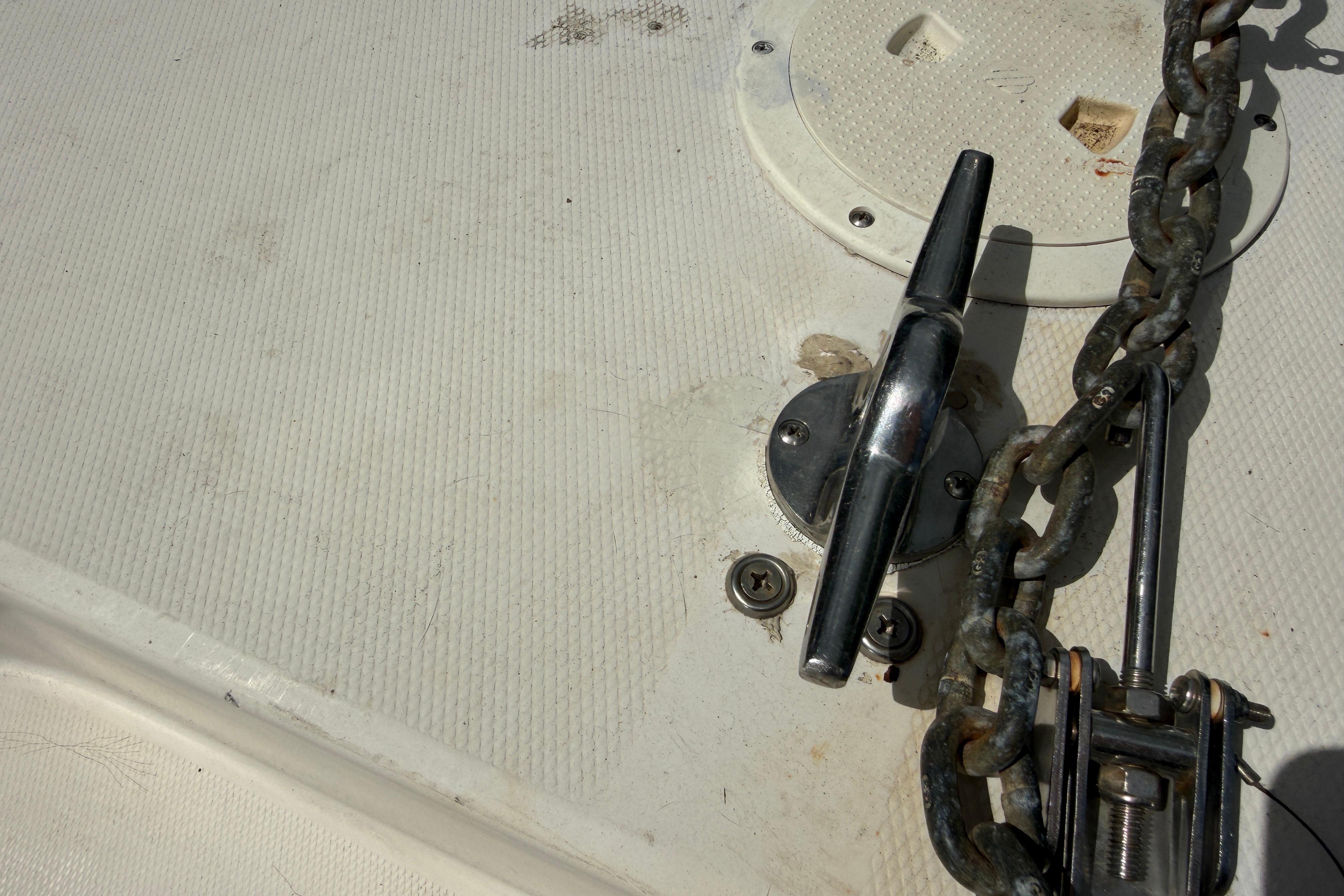 Anchor chain and cleat on 1987 Grady-White Seafarer 226 boat deck.