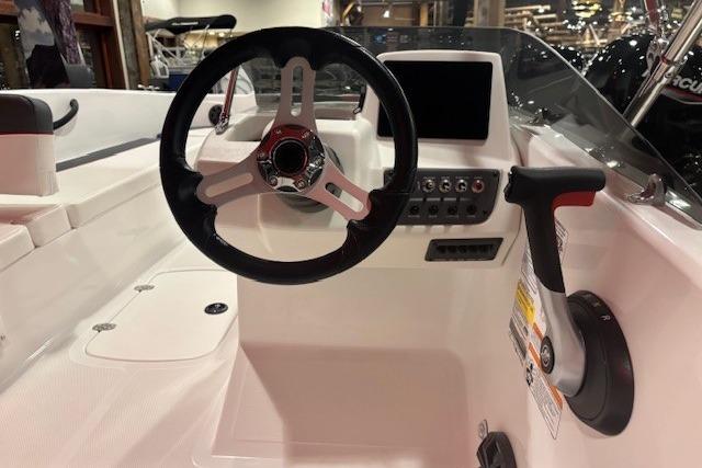 2026 Tahoe T18 boat cockpit with steering wheel and control panel.