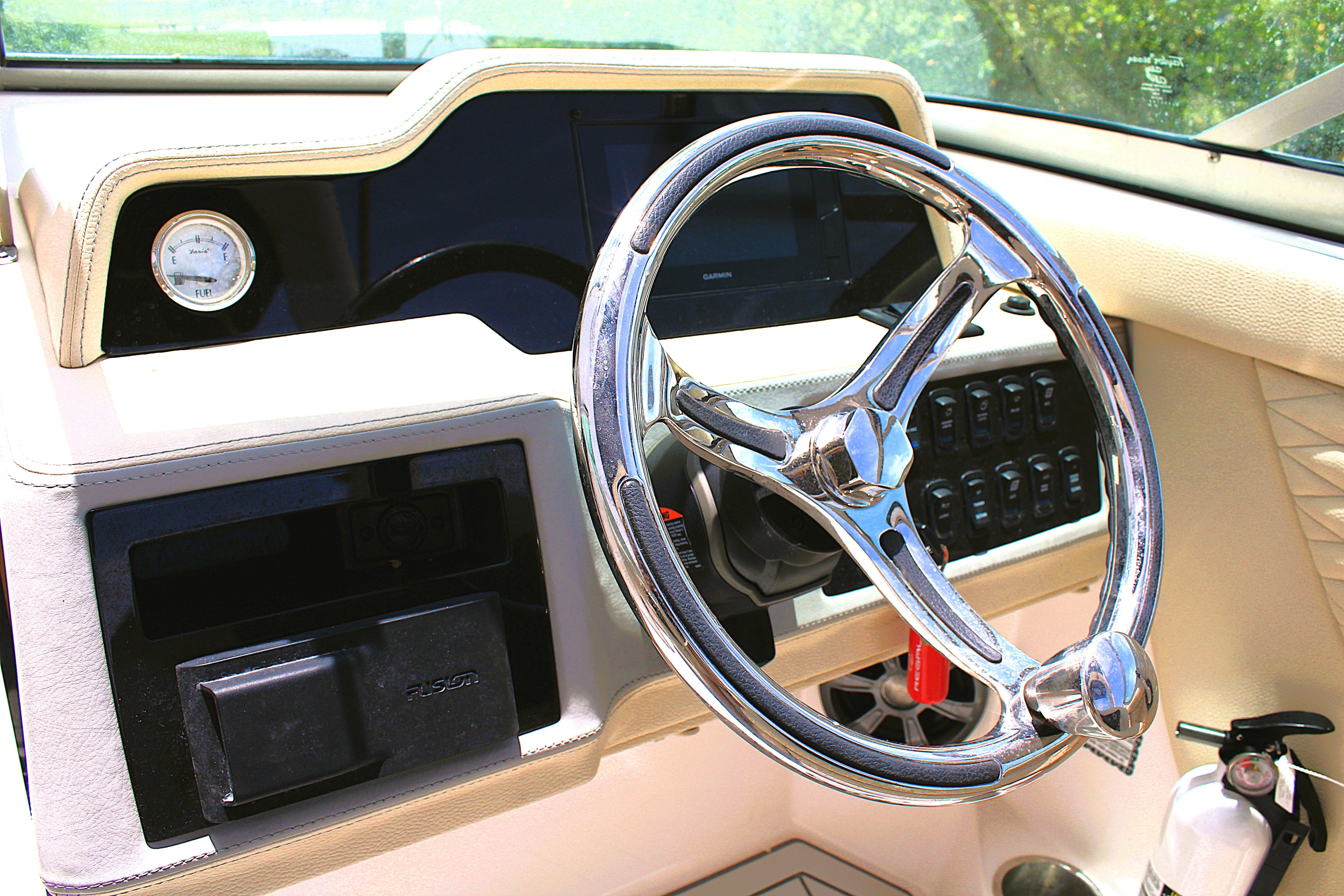 Steering wheel and dashboard of 2021 Regal 26 OBX boat, featuring modern controls.