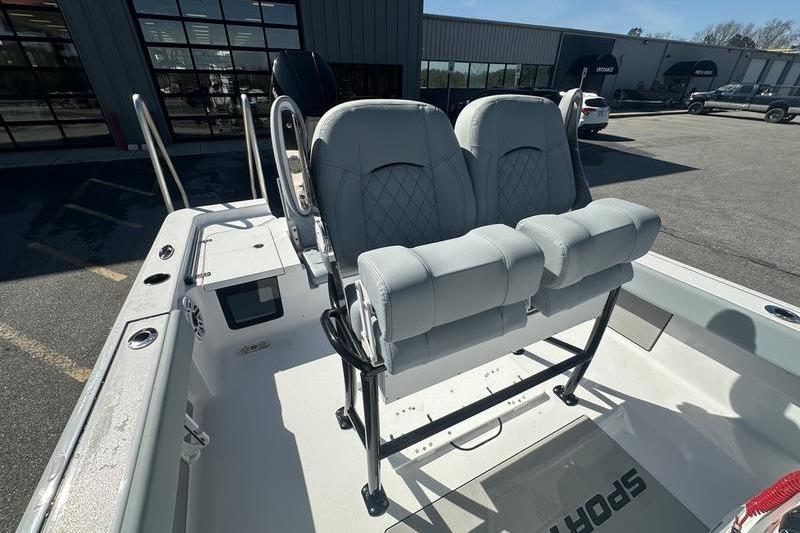2026 Sportsman Masters 247 Bay Boat with dual cushioned seats in a showroom.