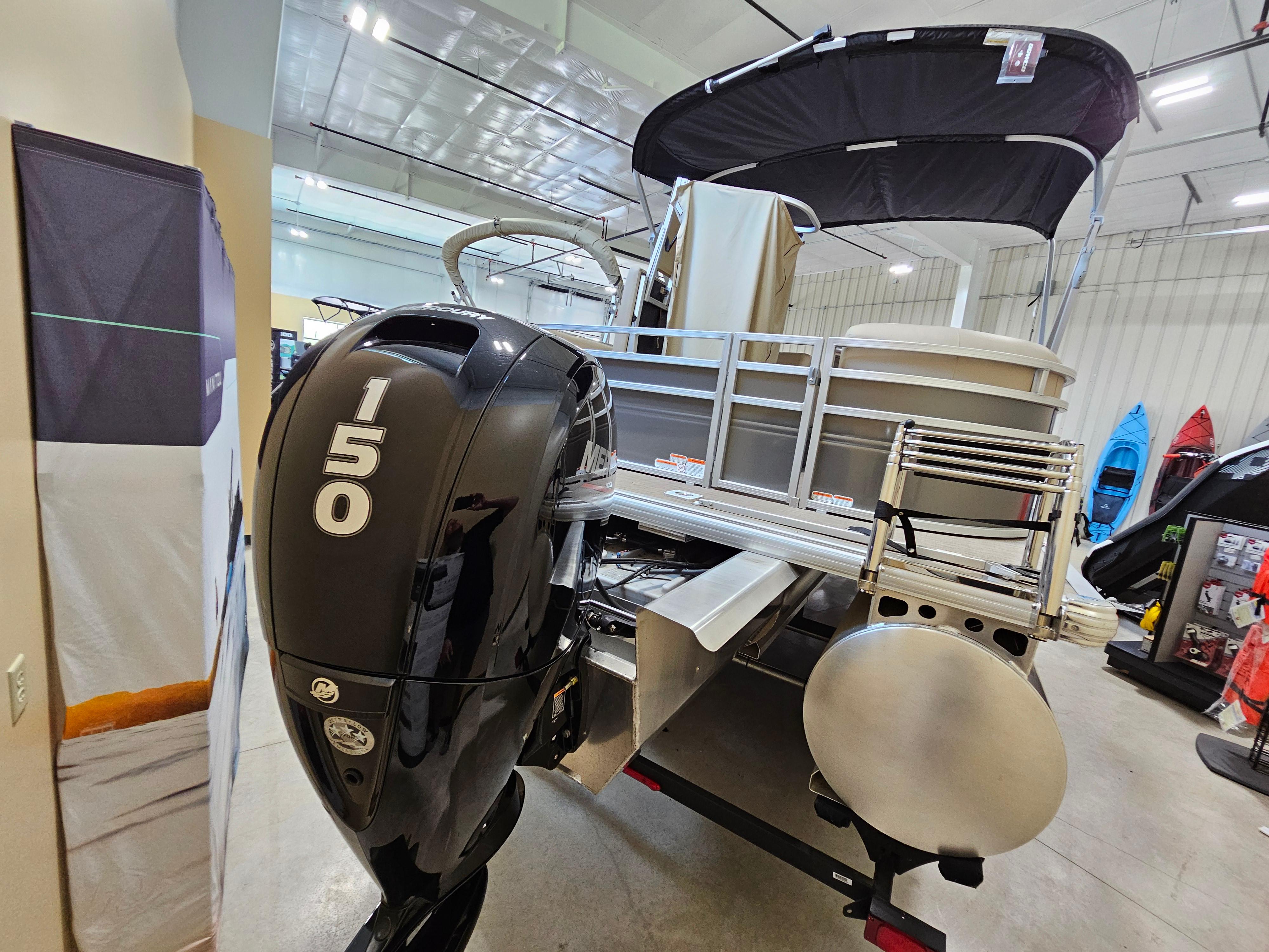 2024 Sun Tracker Party Barge 22 RF XP3 with 150 HP engine in showroom.