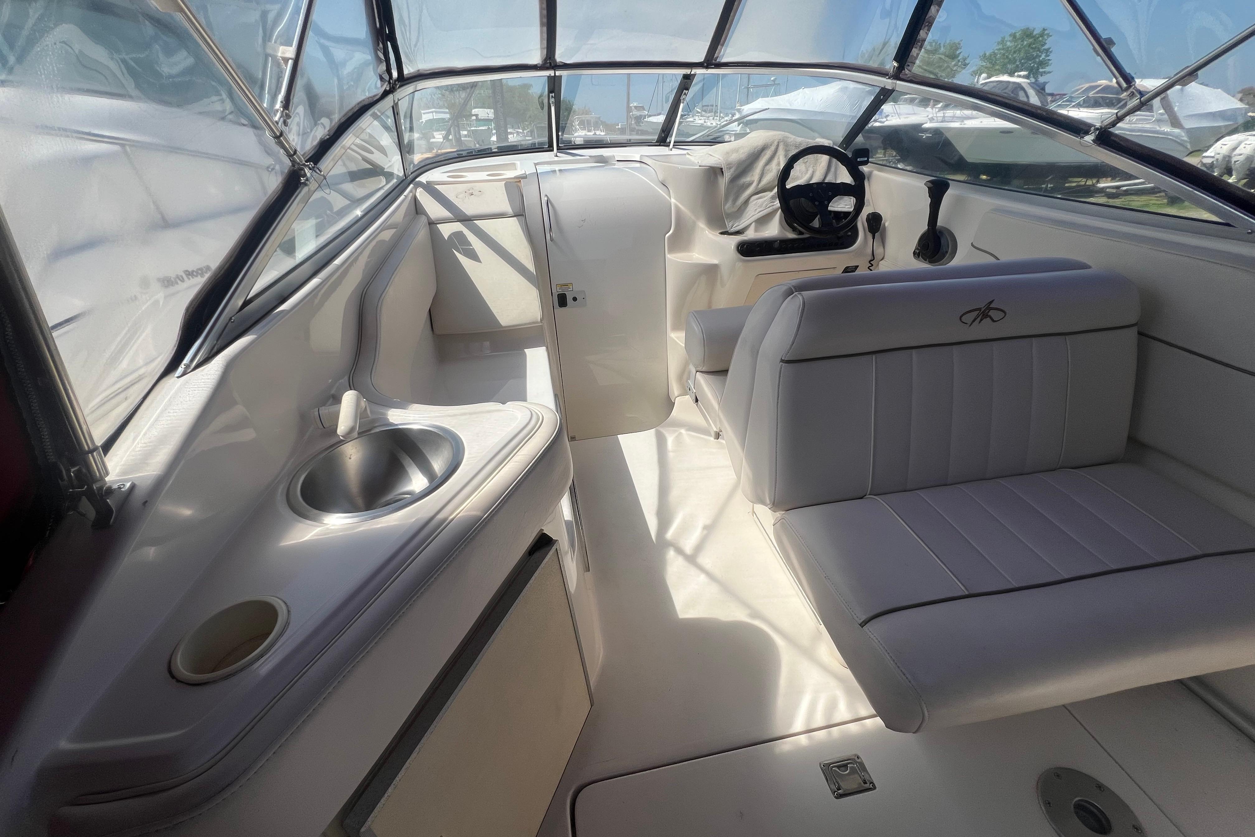 Interior of a 2002 Monterey 262 Cruiser boat with seating and sink.