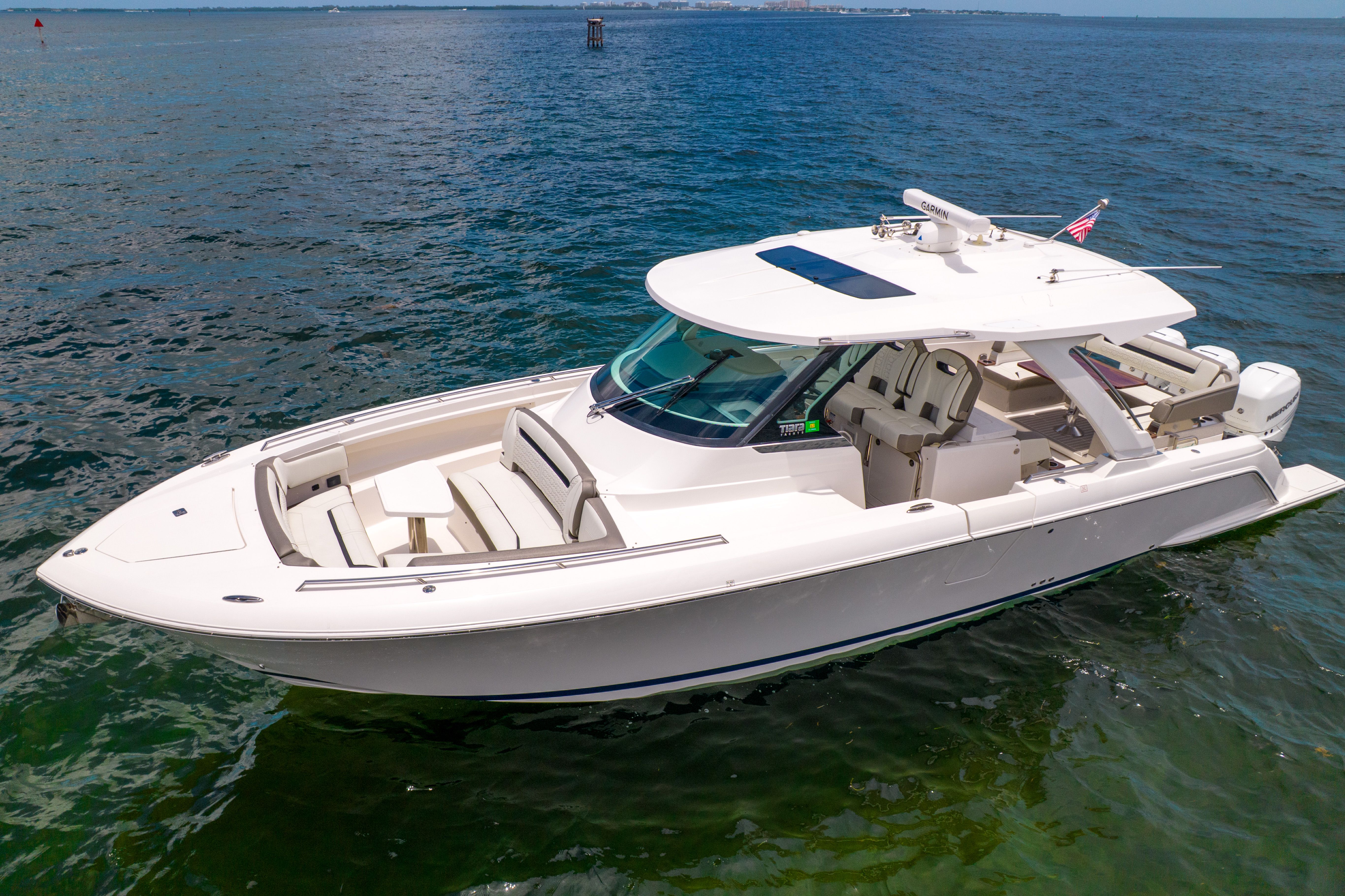 2023 Tiara Yachts 38 LS on the water with sleek design and spacious deck.