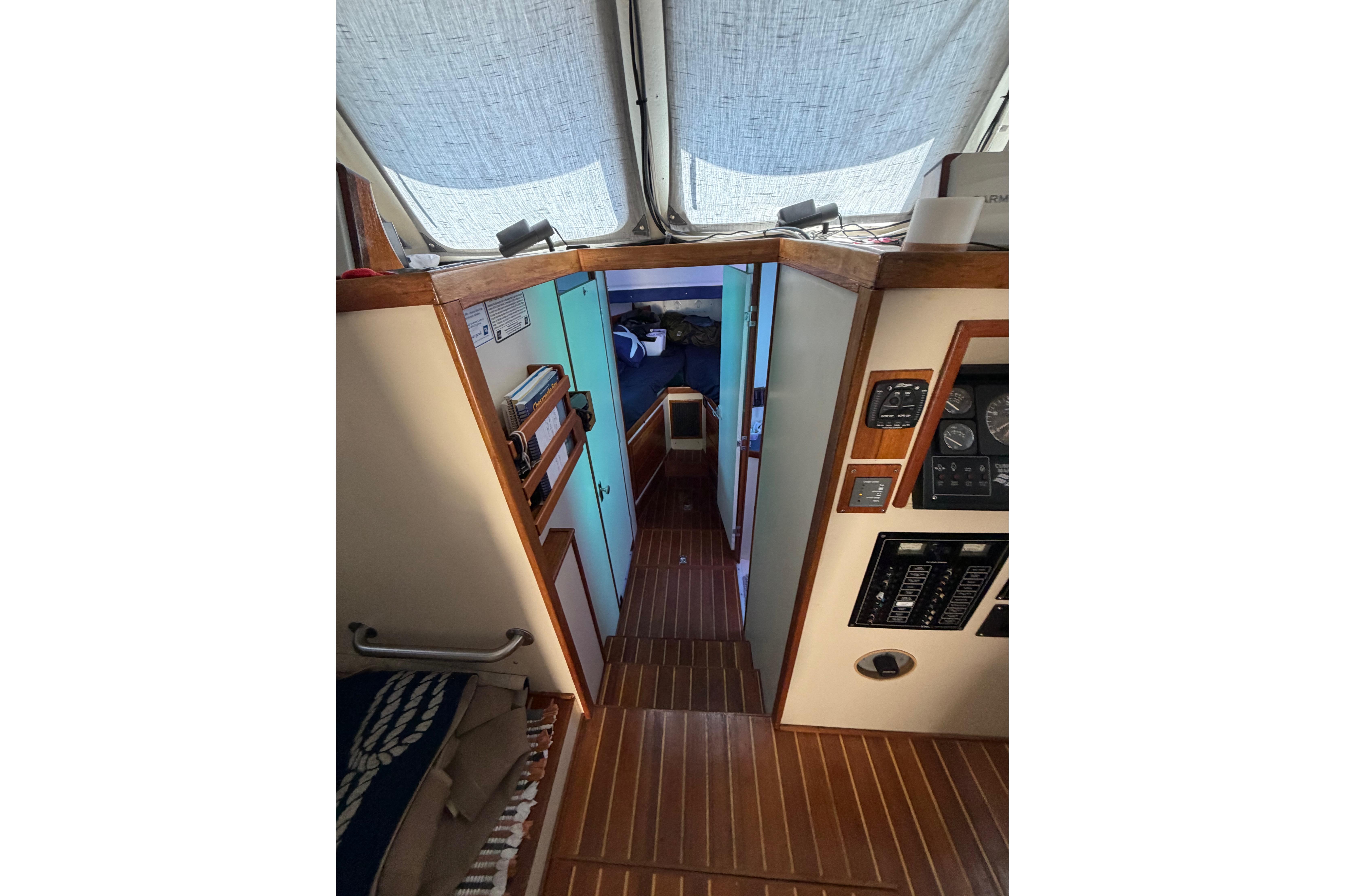 Interior view of a 1997 Rosborough Trawler, featuring wood paneling and nautical instruments.