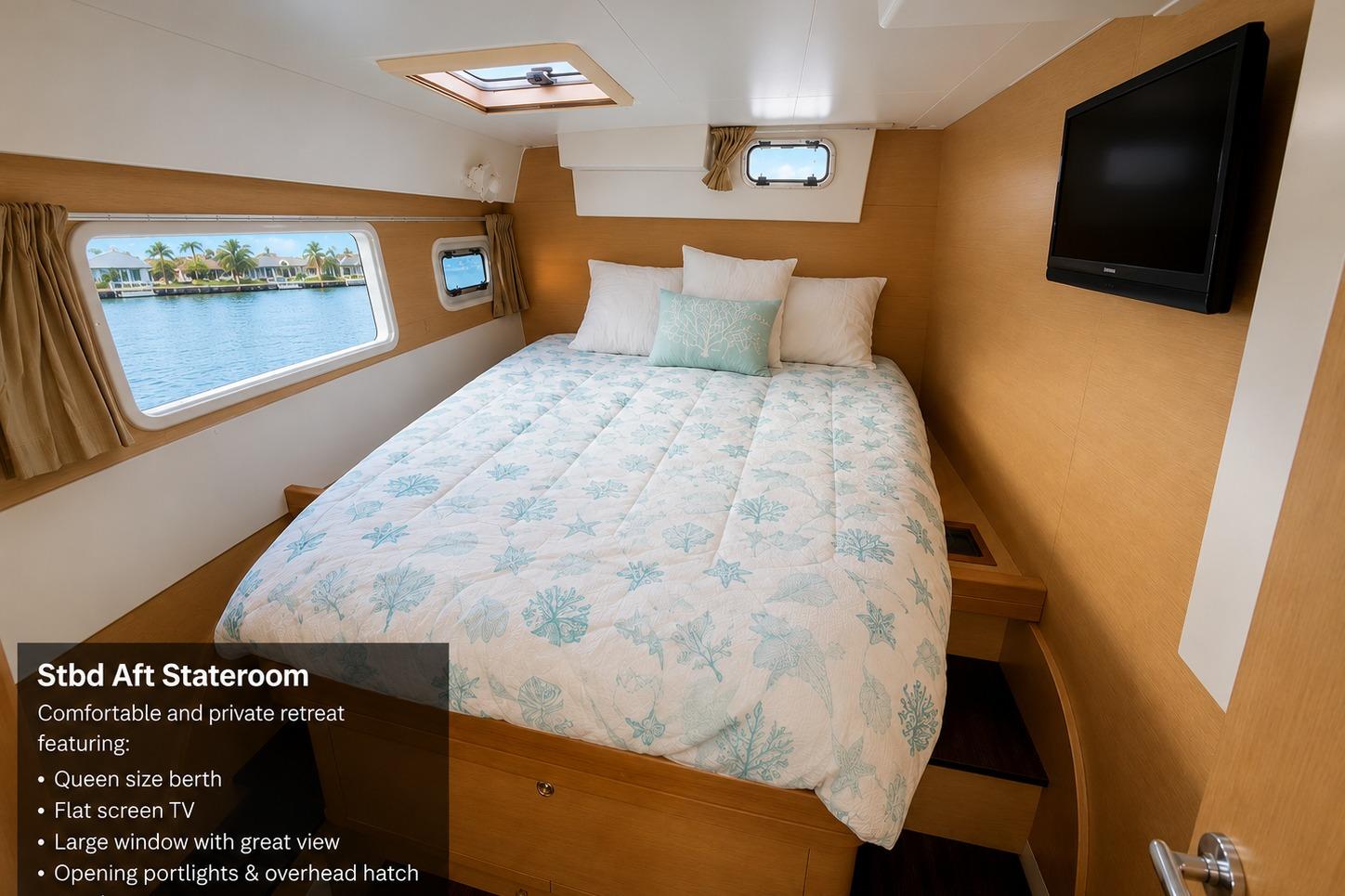 Stateroom in 2010 Lagoon 421 yacht with queen bed, flat screen TV, and scenic window view.