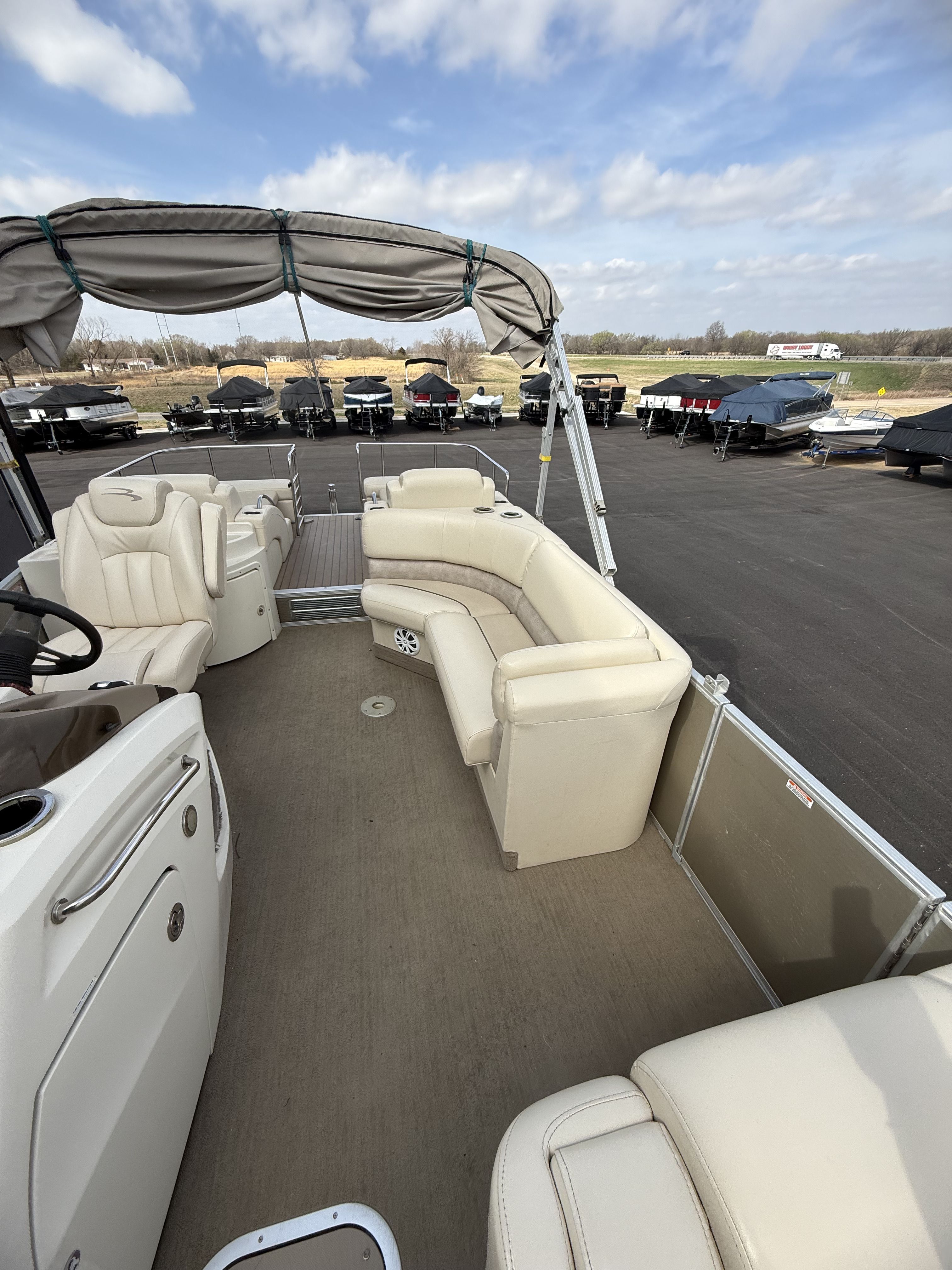 2014 Bennington 2575RCW-I/O pontoon boat with beige interior and canopy.